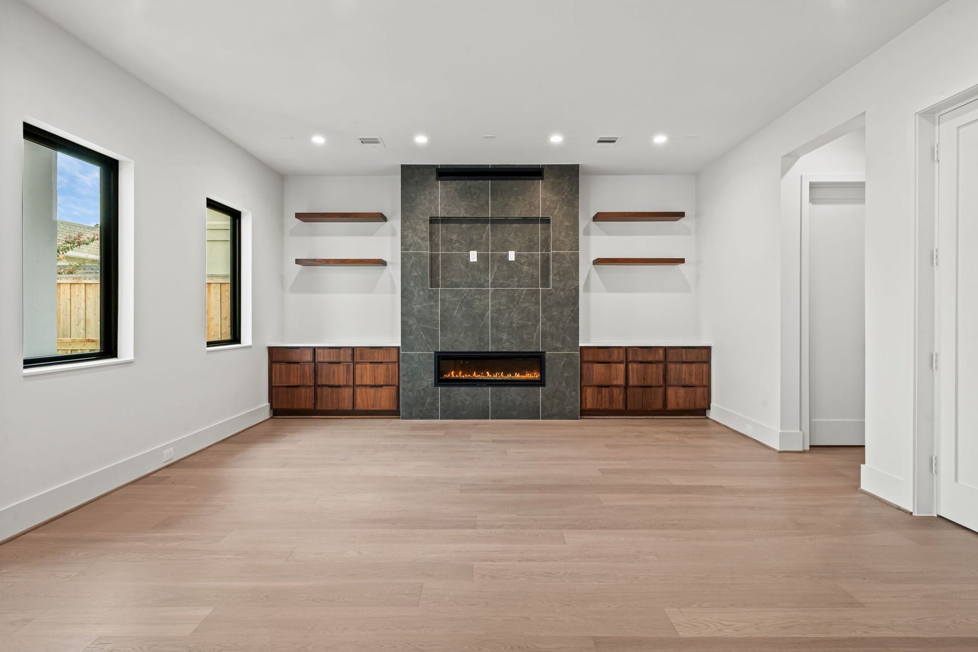 5409 Chevy Chase, #A, Houston, TX 77056 First-floor living area with built-ins and gas-log fireplace.