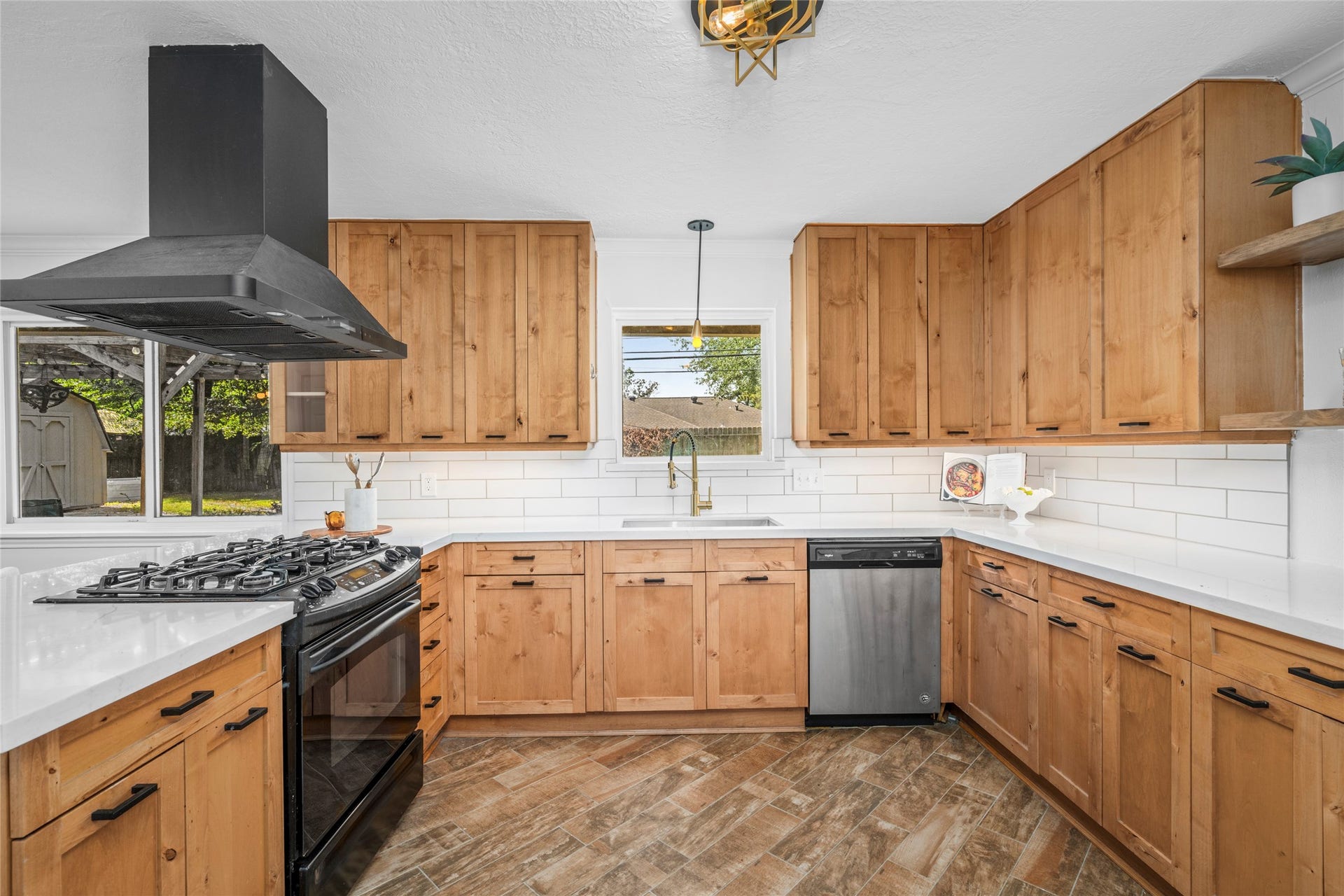 10519 Londonderry Drive, Houston, TX 77043 The kitchen updates include new countertops and backsplash, just the right amount of floating shelves, and a new sink and fixtures