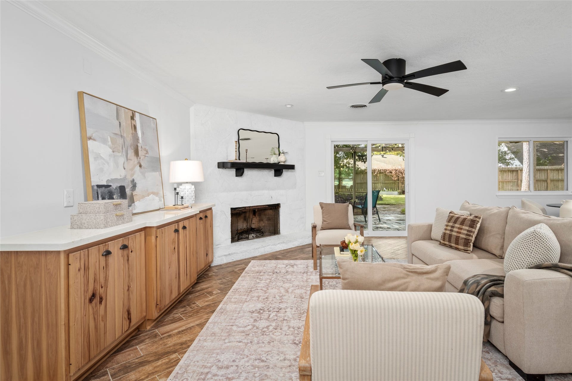 10519 Londonderry Drive, Houston, TX 77043 The heart of the living room is the corner, wood-burning fireplace and delightful built ins. Natural light flows from the new sliding doors opening to the spacious backyard.