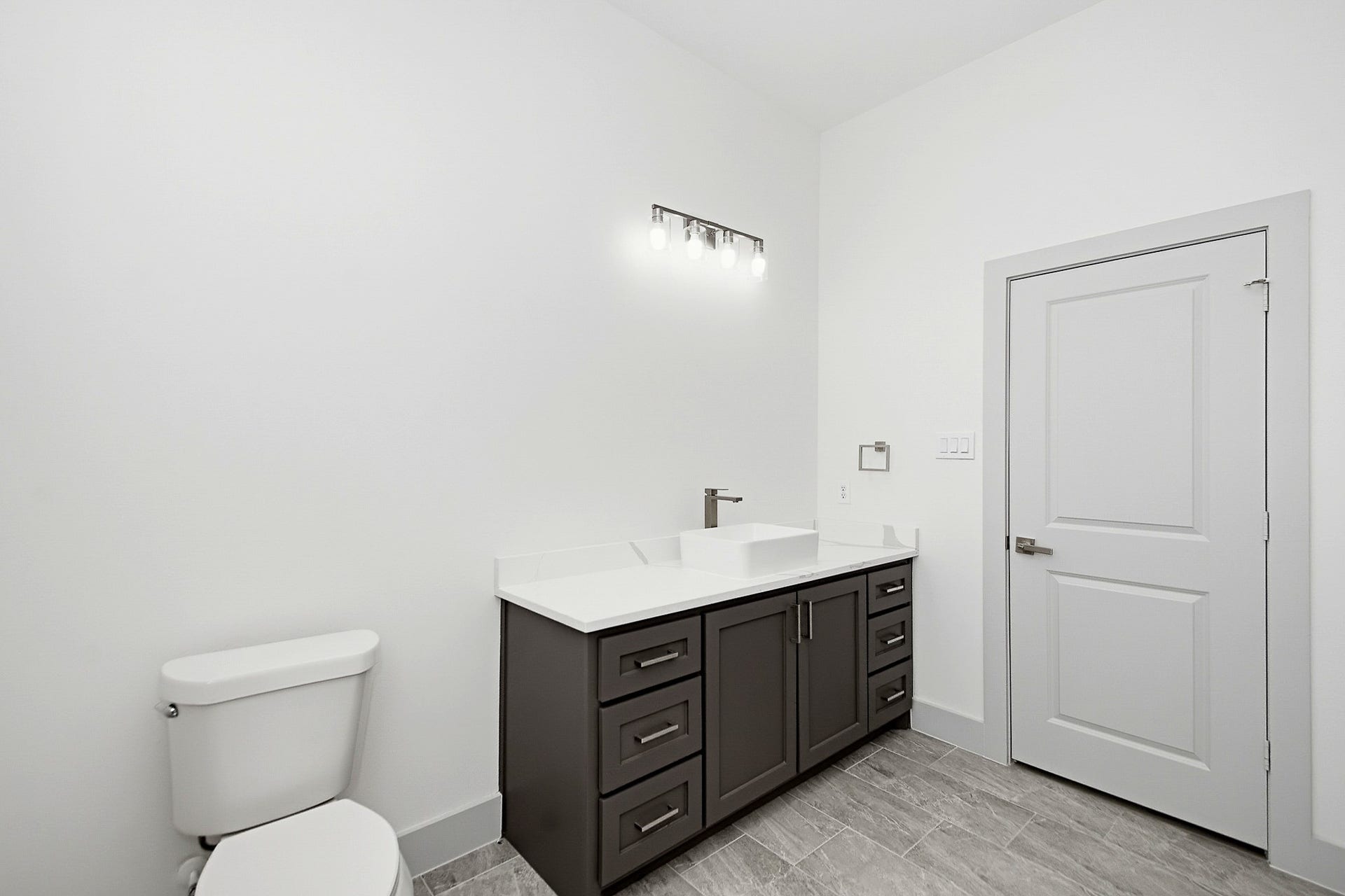 619 Longhorn Trail, Angleton, TX 77515 Bright and modern 10x10 secondary bathroom featuring a sleek vanity with ample storage, contemporary lighting, and elegant tile flooring.