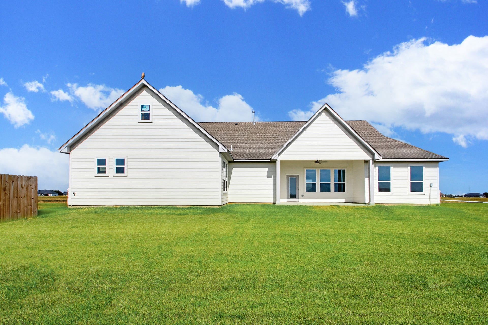 619 Longhorn Trail, Angleton, TX 77515 Charming modern home with clean white siding, a spacious backyard, and a covered patio perfect for outdoor relaxation. Property sits on a 1 acre lot.