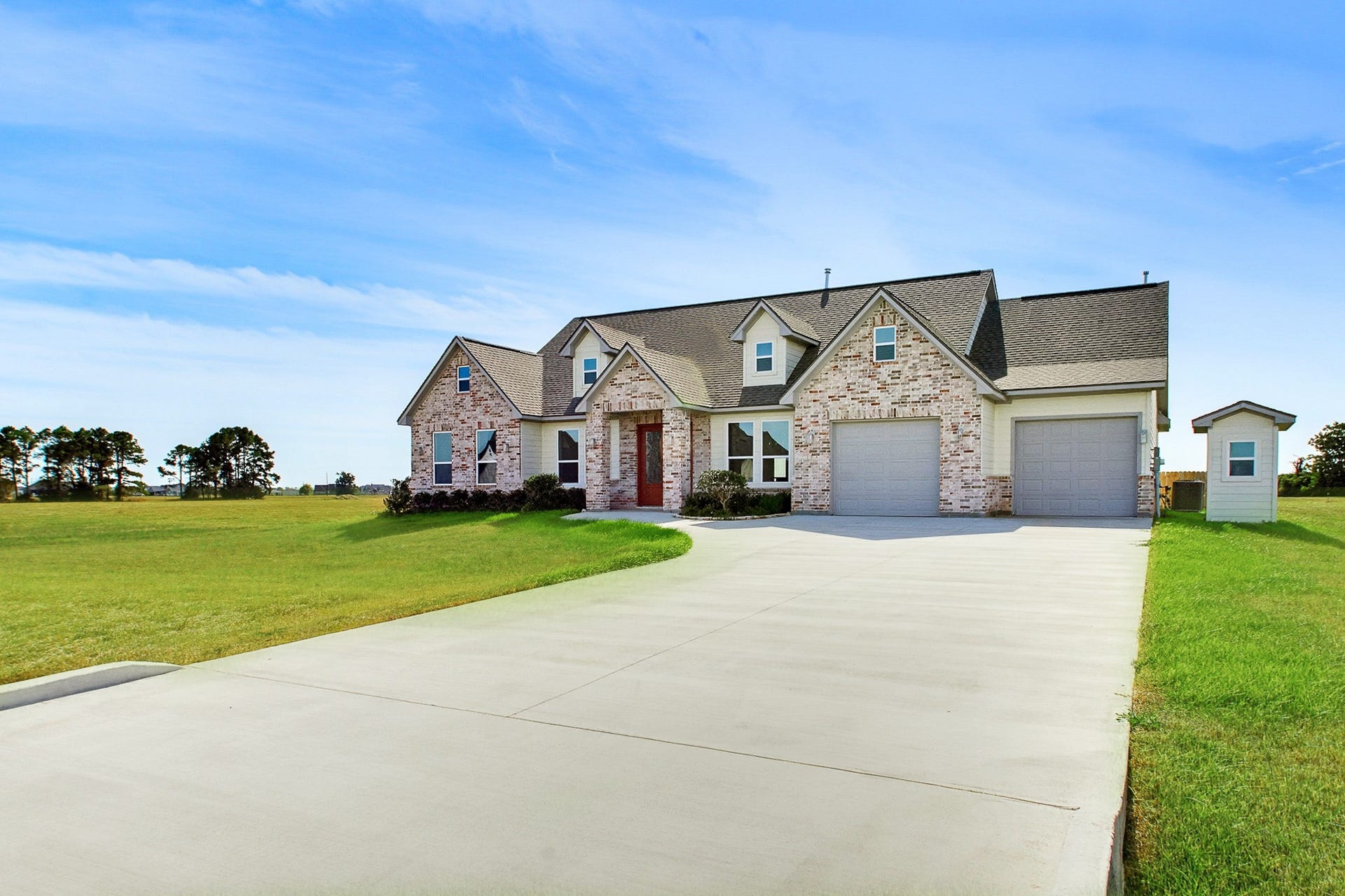619 Longhorn Trail, Angleton, TX 77515 Charming 2389 sq.ft. brick home with a spacious double driveway, 549 sq.ft. dual garages, and expansive green one acre lawn, offering a perfect blend of comfort and style in a serene Bar X Ranch setting.