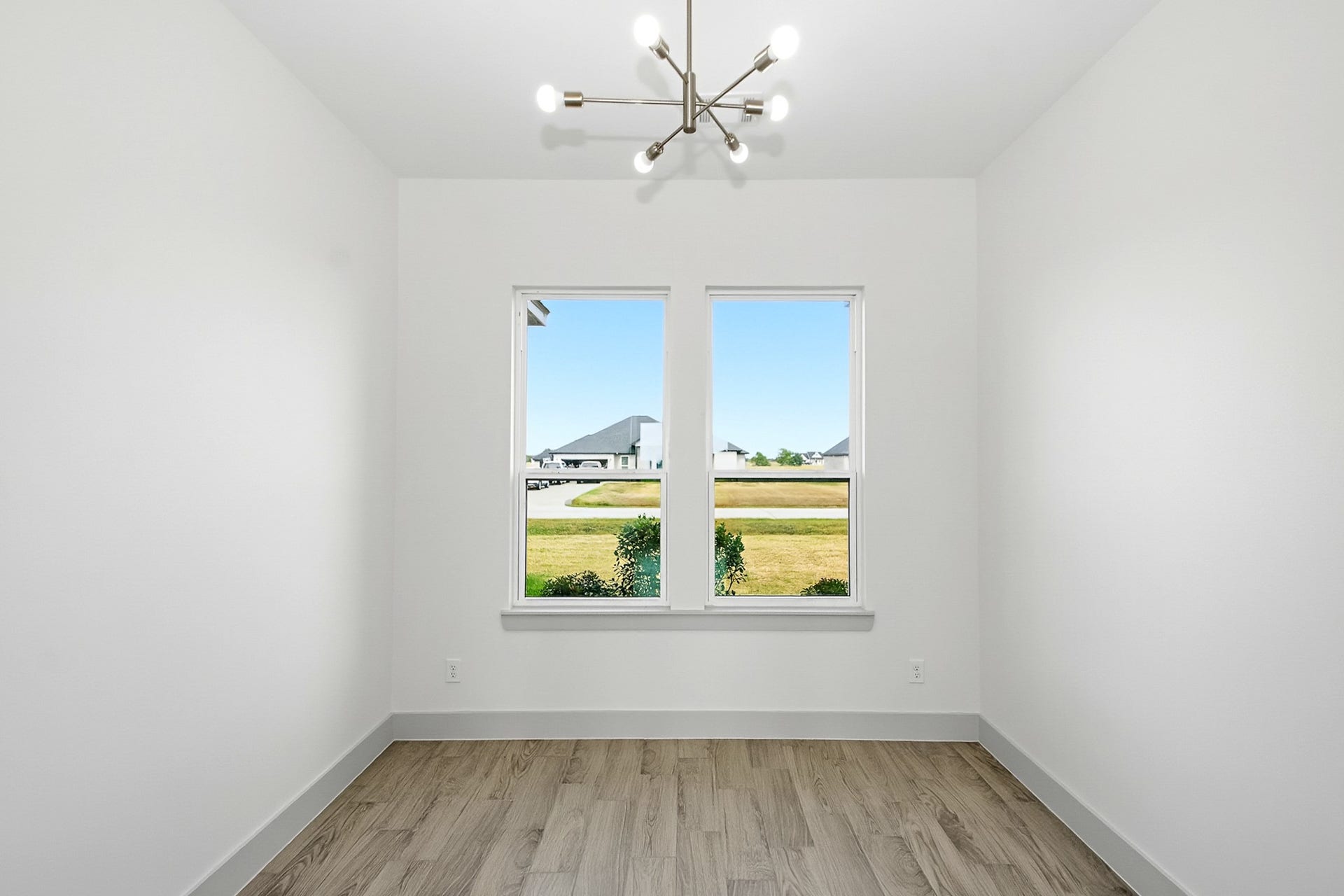 619 Longhorn Trail, Angleton, TX 77515 Bright and airy 10.5x10 office space with large windows offering beautiful natural light, complemented by sleek tile flooring and a modern light fixture.