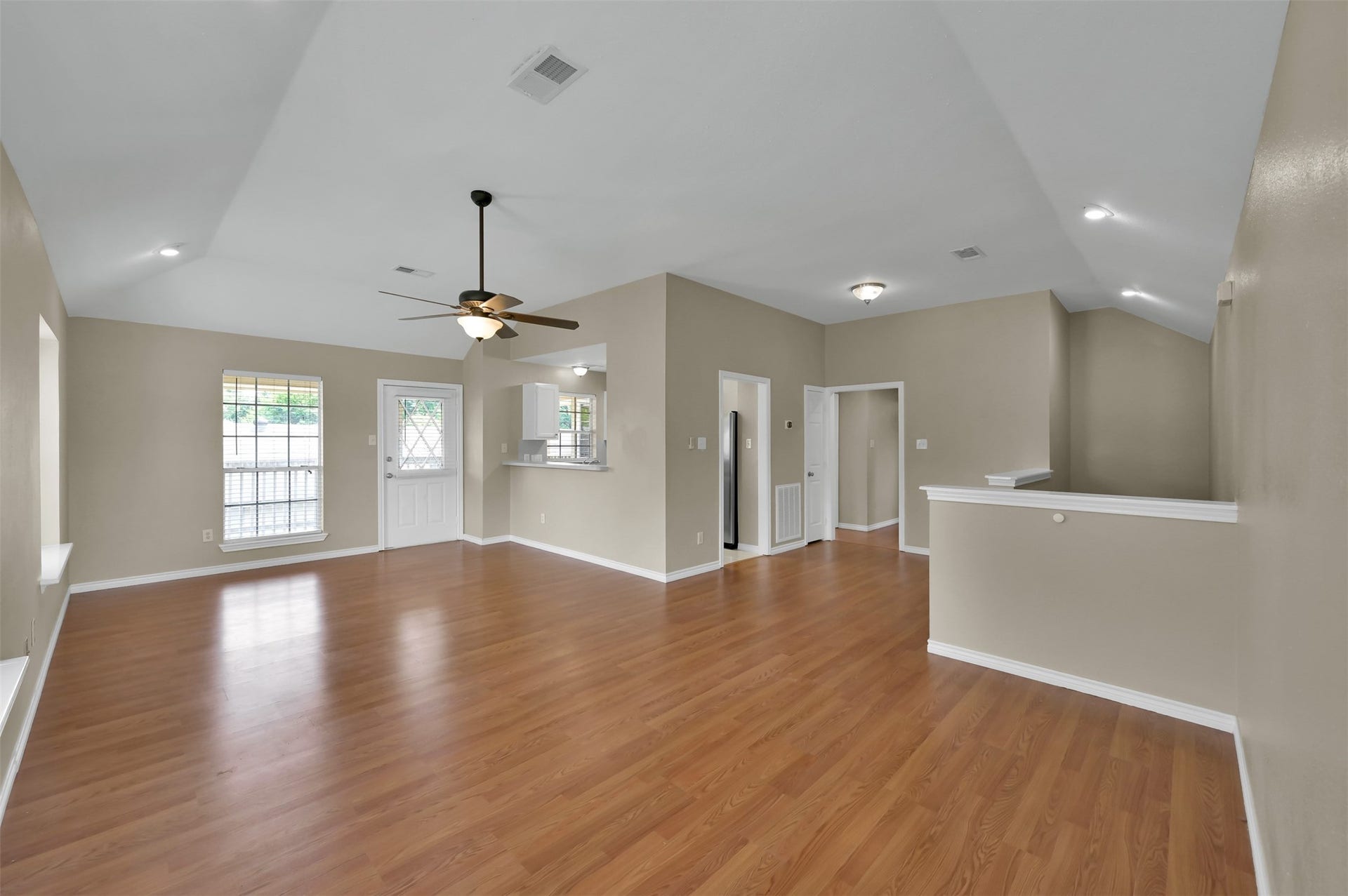1141 Lovett Street, Tomball, TX 77375 Open-concept living area with warm wood flooring, neutral walls, and ample natural light, perfect for entertaining or relaxing.