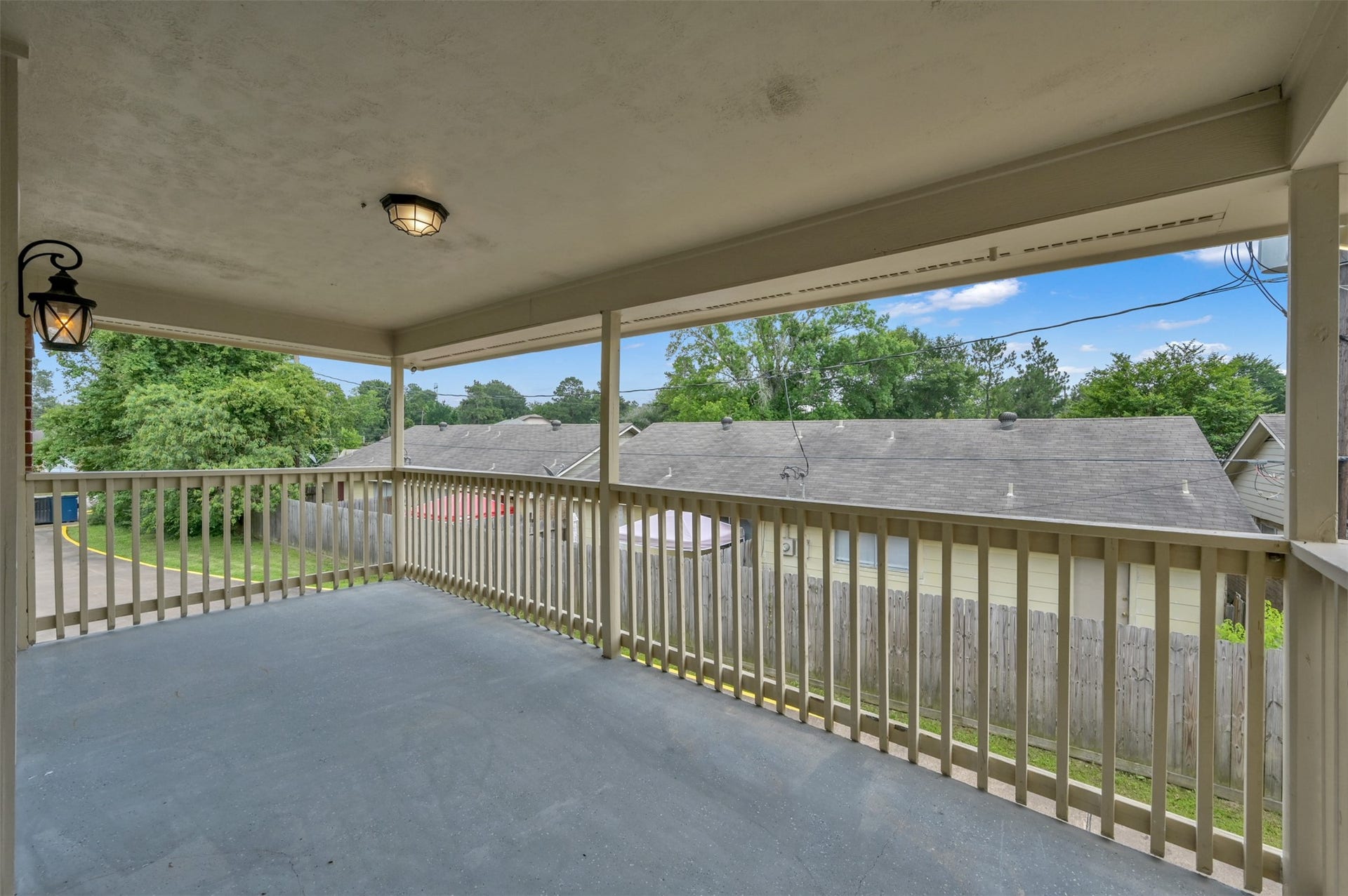 1141 Lovett Street, Tomball, TX 77375 Spacious private covered balcony offering a serene view of the surrounding neighborhood, perfect for relaxing or entertaining.