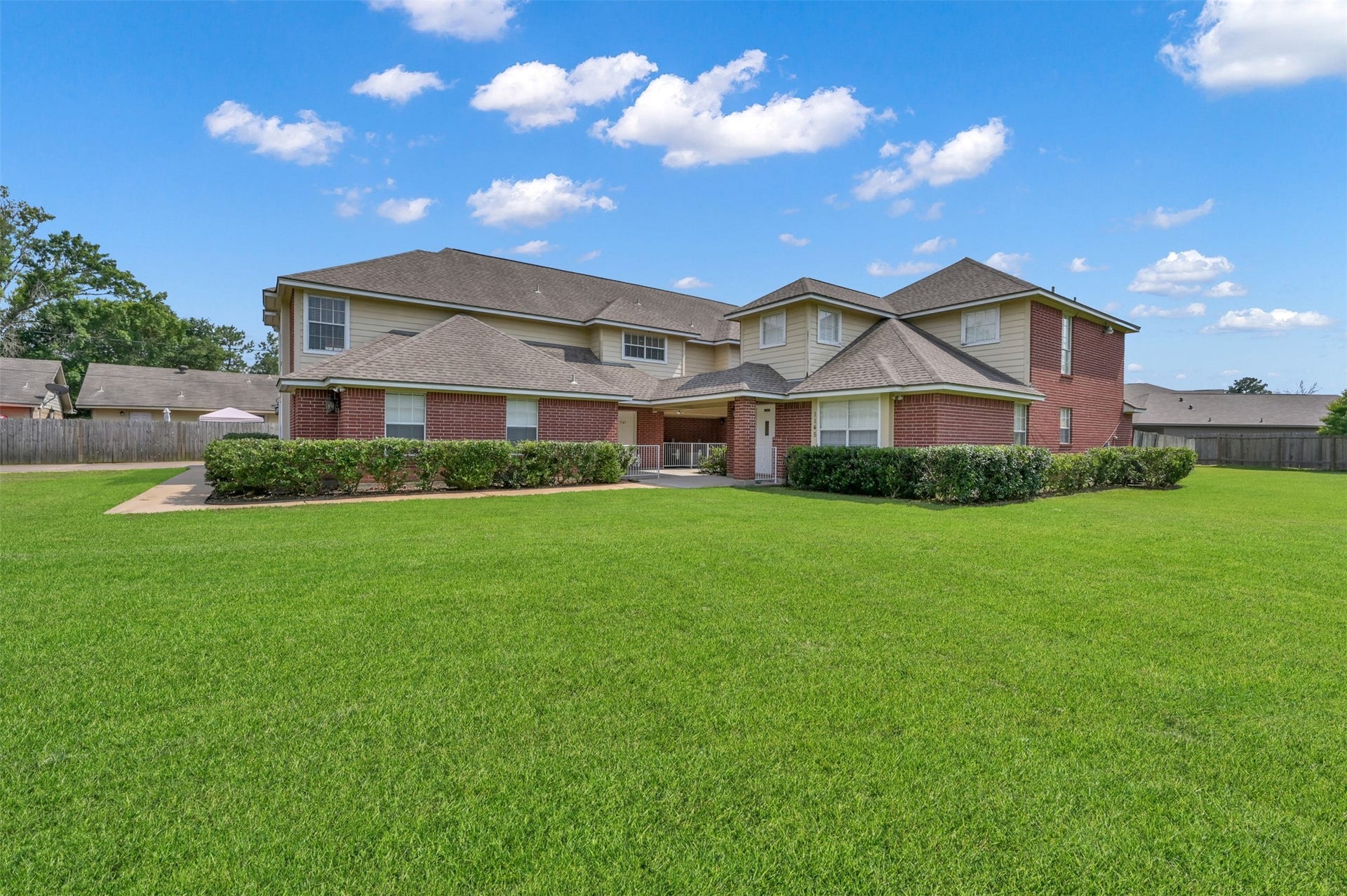 1141 Lovett Street, Tomball, TX 77375 Spacious two-story brick townhome with a large, well-manicured common area lawn.