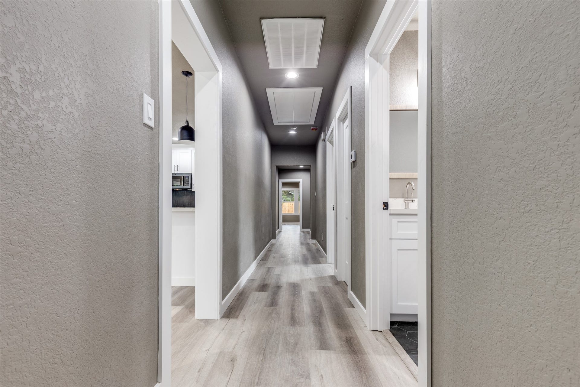 Bright hallway with clean new finishes and recessed lighting, giving the home an airy, move in ready feel.