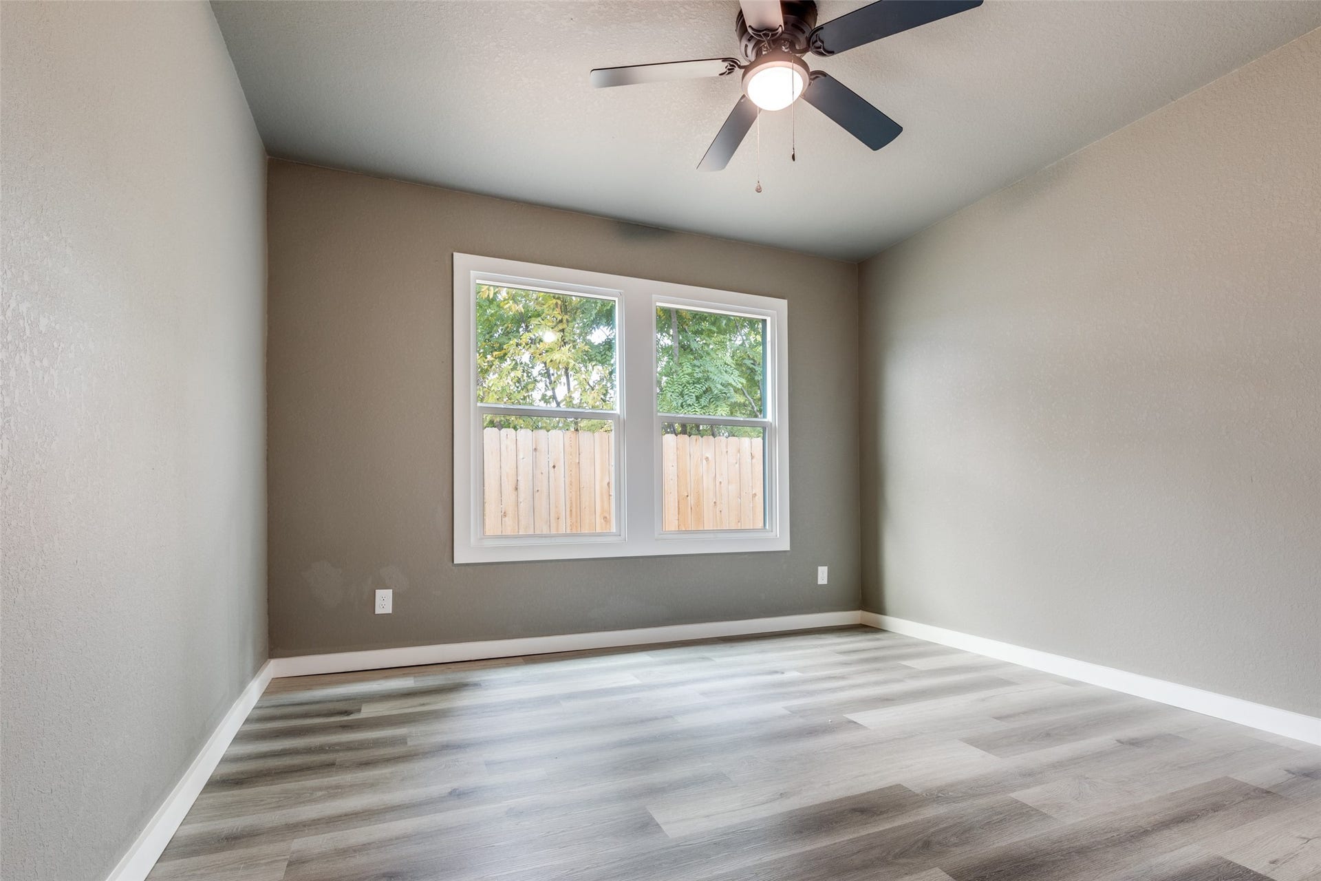 Comfortable secondary bedroom with great light and fresh finishes, ready for kids, guests, or your work from home setup.