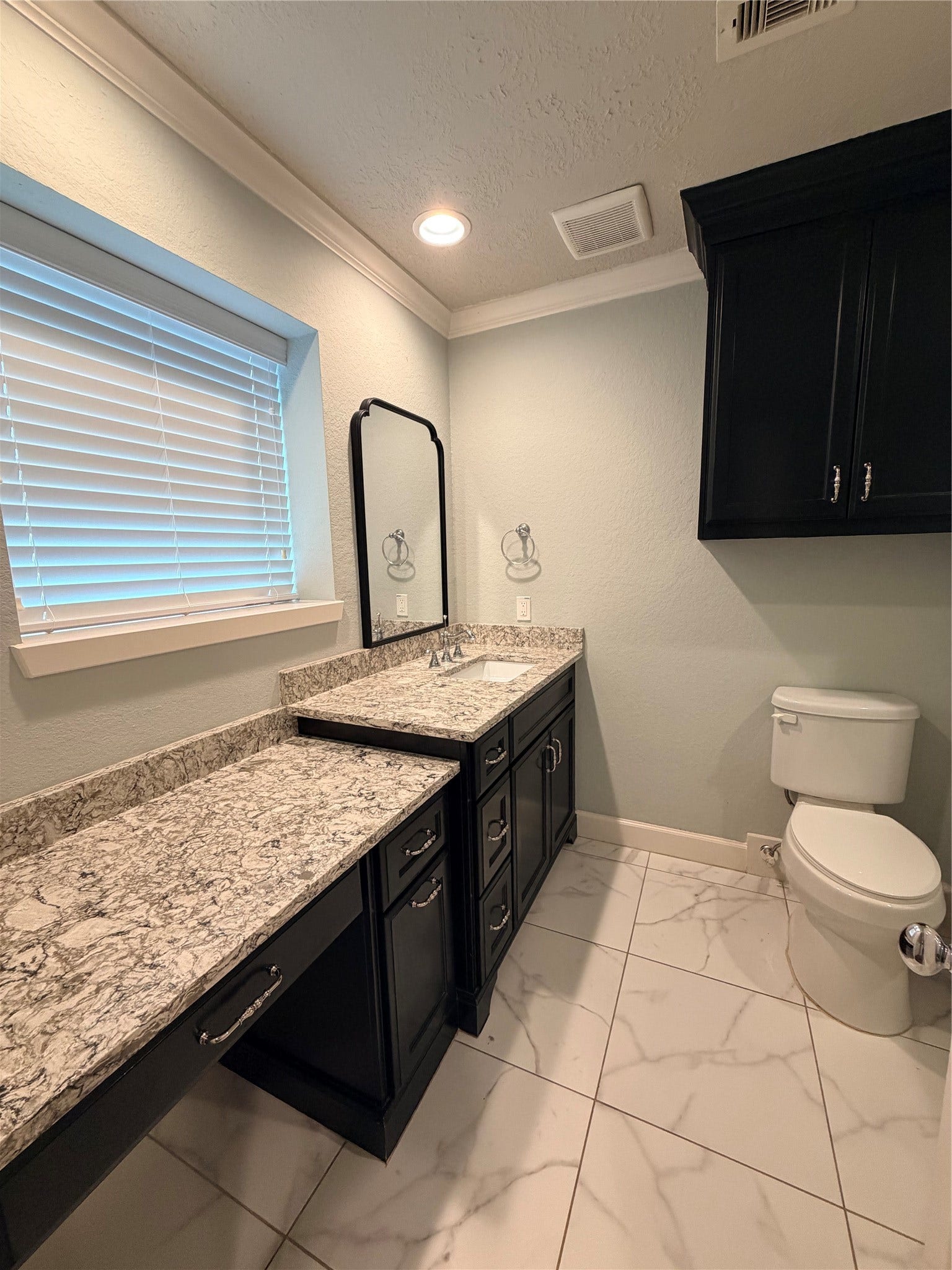 2506 Northern Drive, League City, TX 77573 Primary Bathroom. Granite countertops, custom built-in pullouts for hair tools.