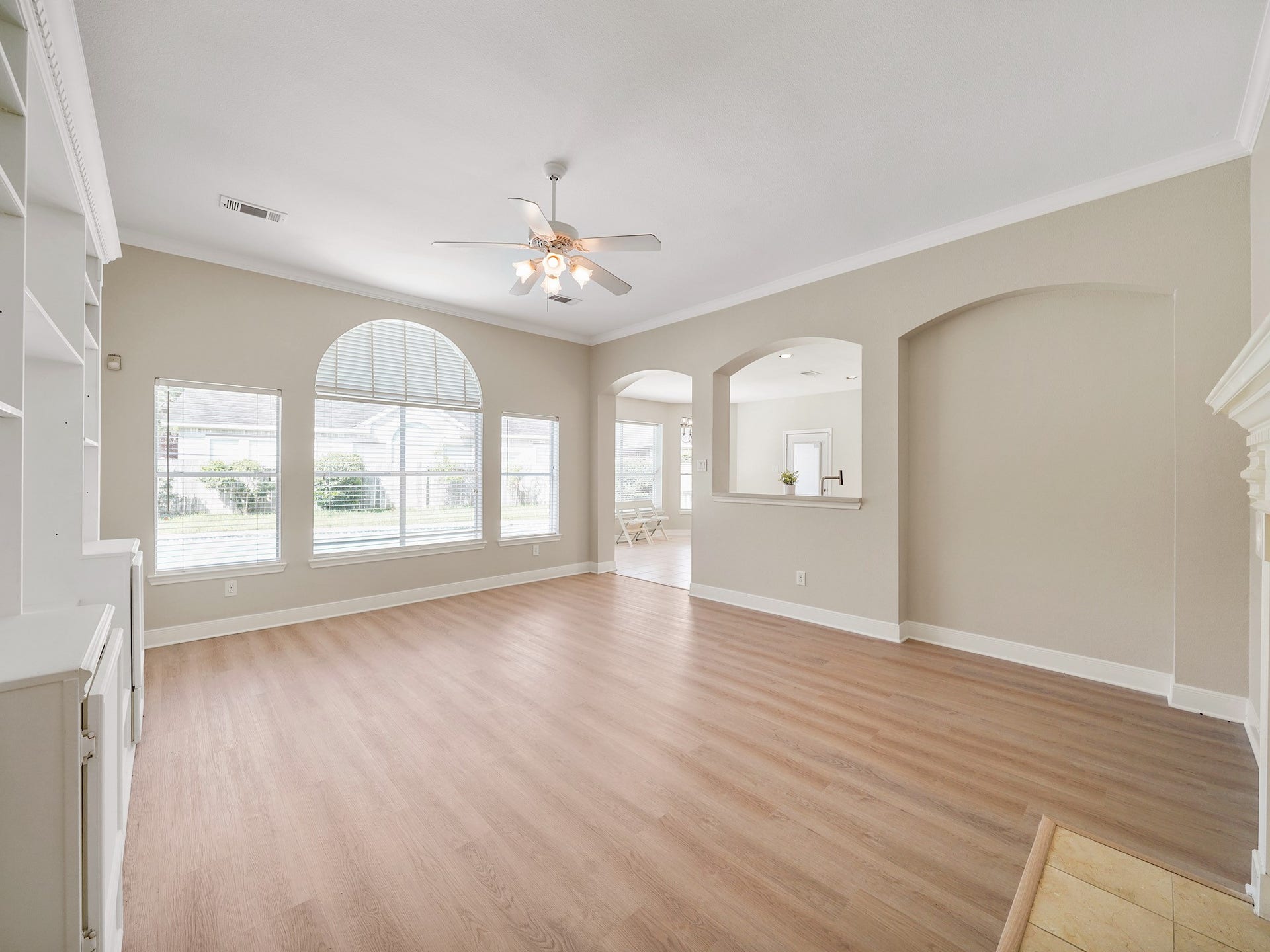 3907 Garnet Falls, Sugar Land, TX 77479 This spacious living area features large windows and offers an open view into the kitchen.