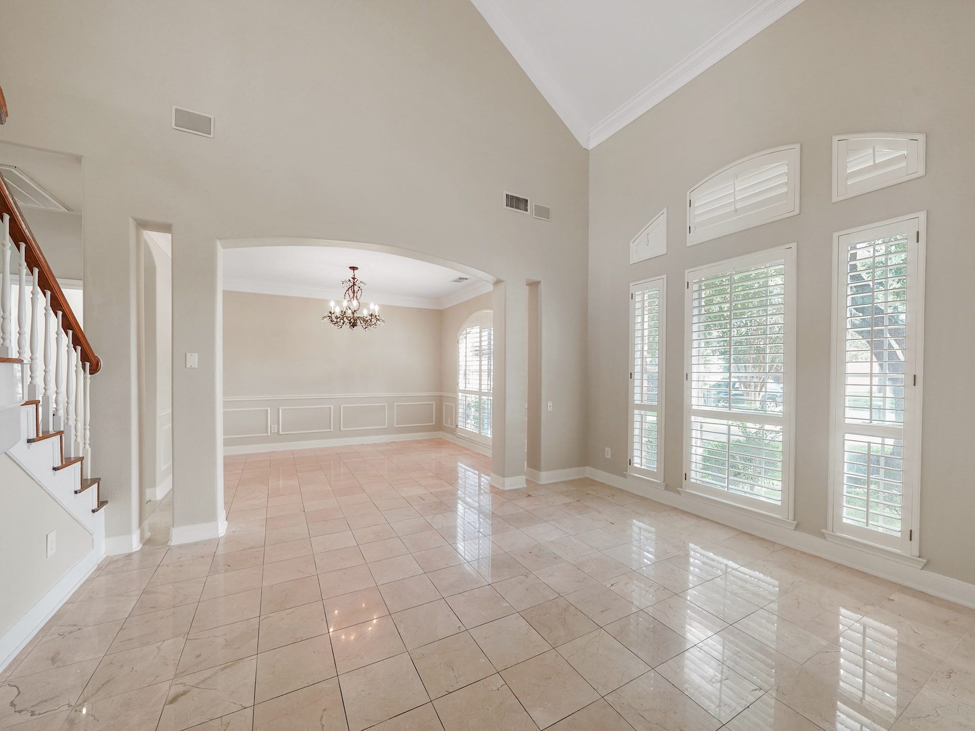 3907 Garnet Falls, Sugar Land, TX 77479 The foyer features high ceilings, large windows with shutters for ample natural light and elegant tile flooring.
