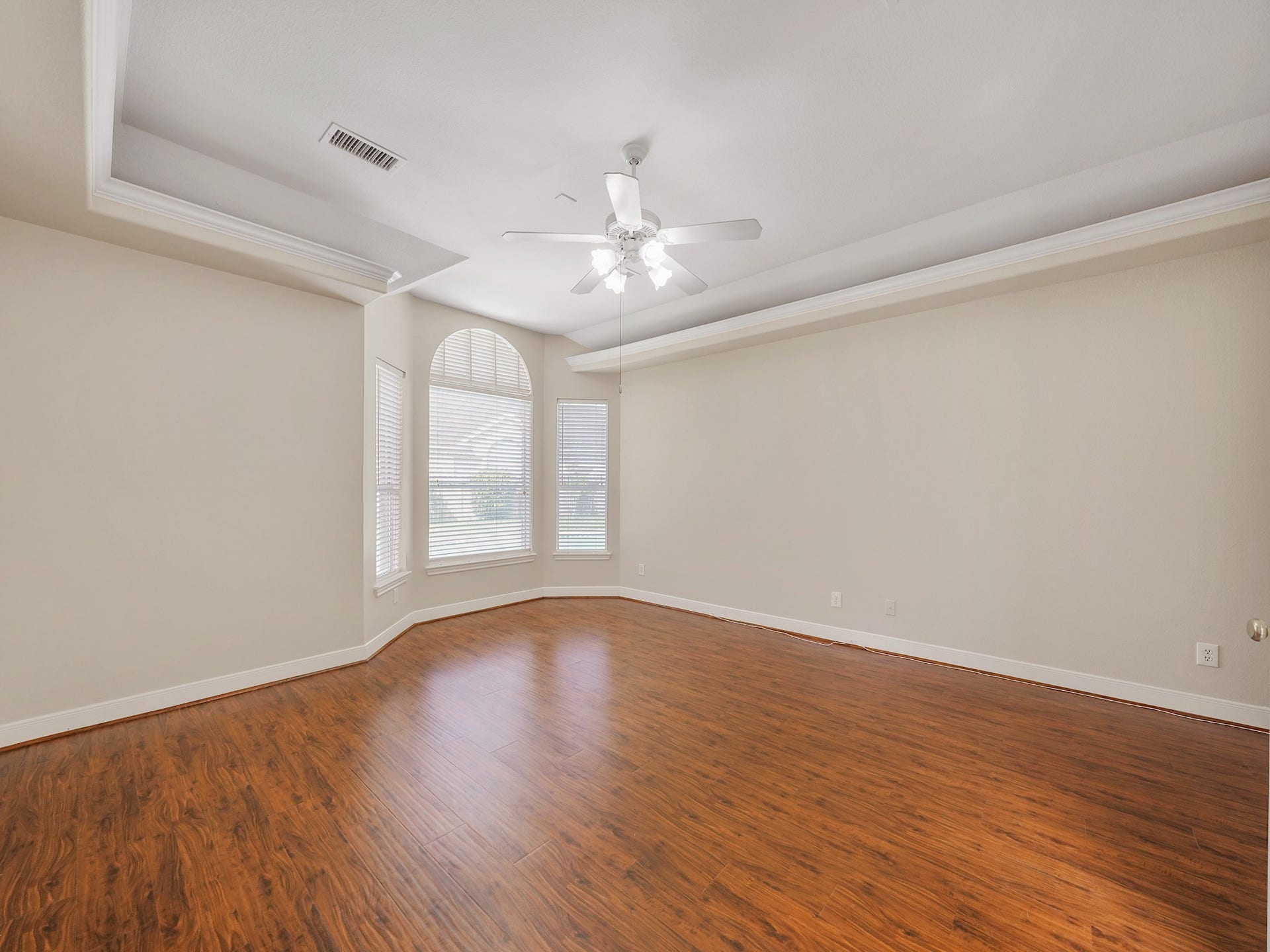 3907 Garnet Falls, Sugar Land, TX 77479 The primary bedroom features elegant hardwood floors and a large bay window facing the private pool.