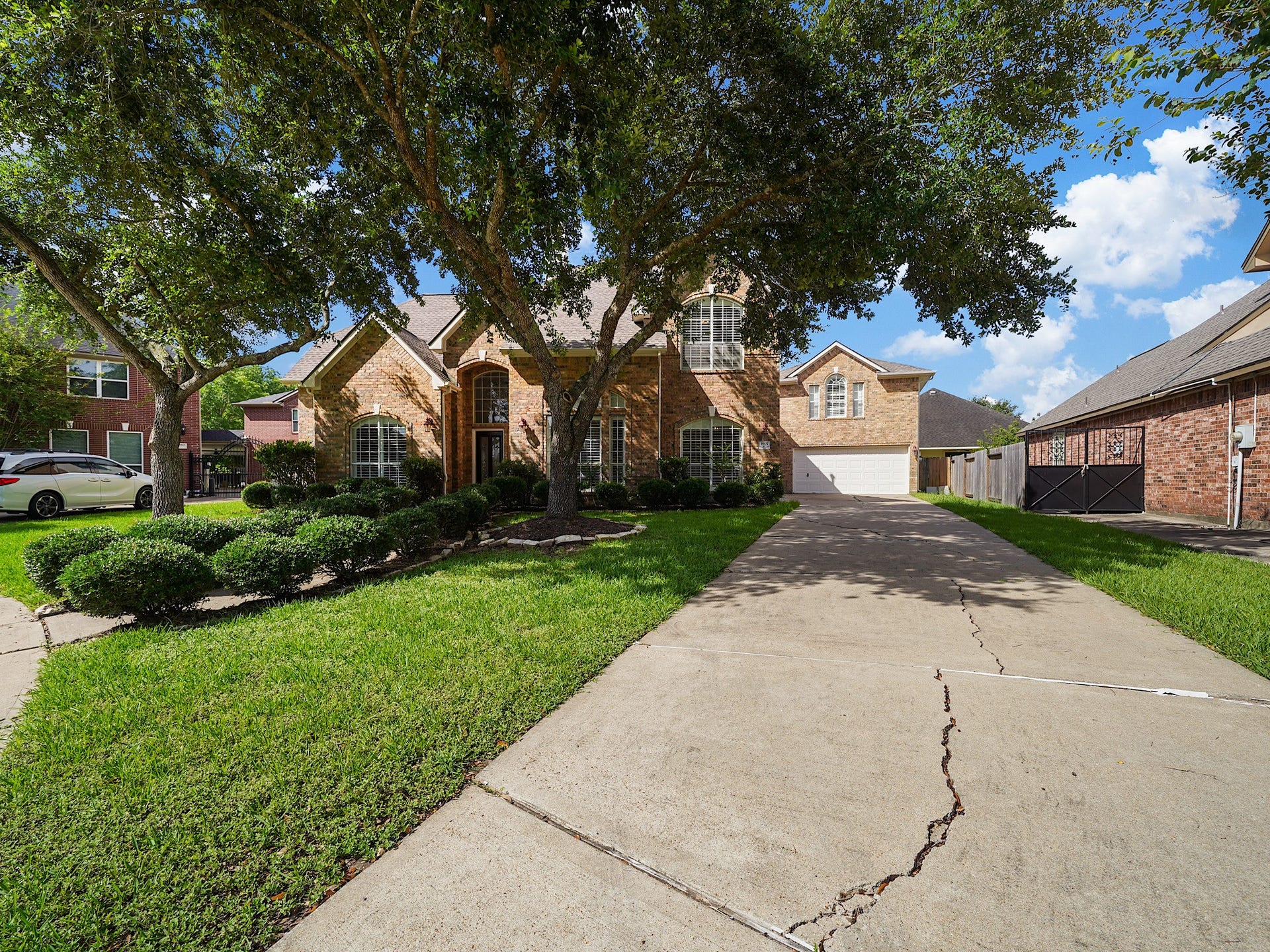 3907 Garnet Falls, Sugar Land, TX 77479 Driveway leads to a two-car garage, offering ample parking.