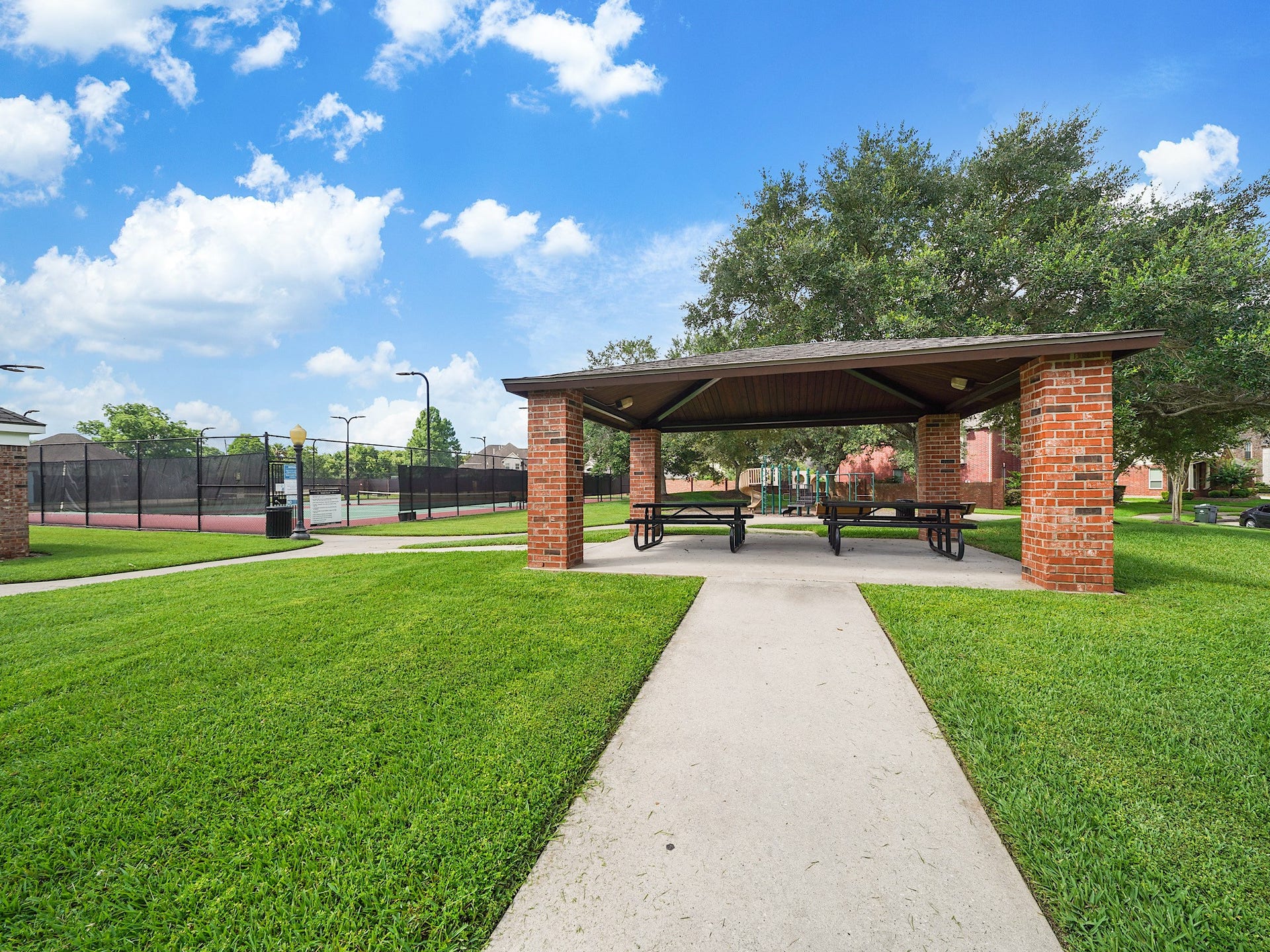 3907 Garnet Falls, Sugar Land, TX 77479 Community area featuring picnic tables, tennis court, pool, and a playground.