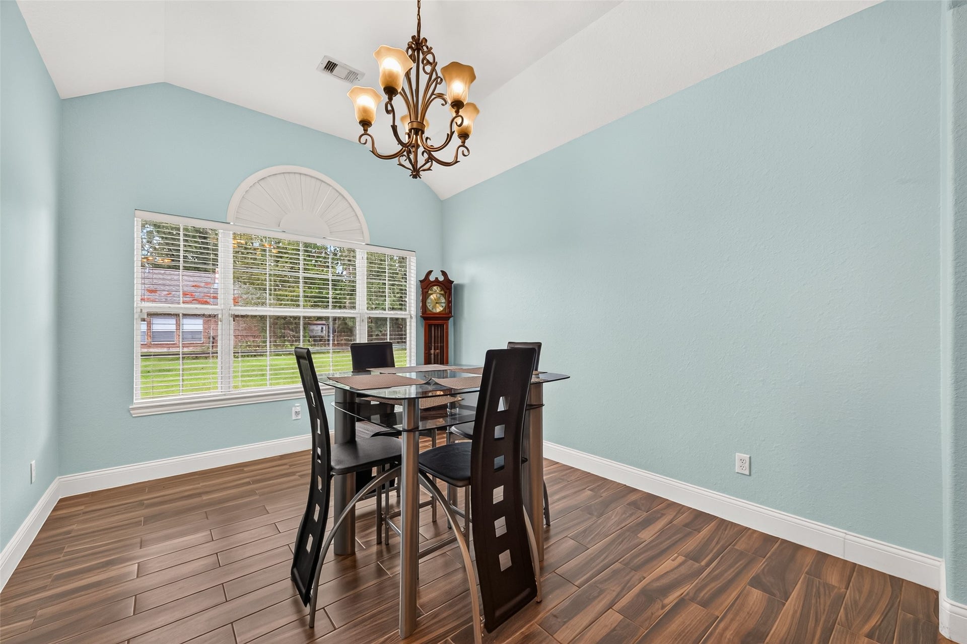 Enjoy gatherings in this spacious formal dining room, complete with a decorative chandelier and large windows overlooking the front yard.