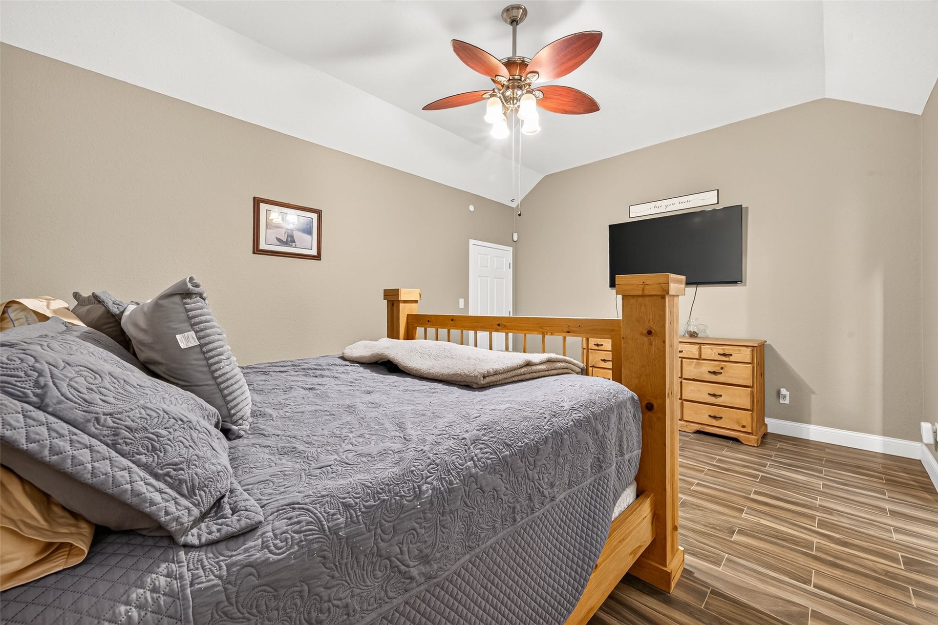 Enjoy the comfort of a generously sized primary bedroom with beautiful flooring and a layout designed for relaxation.