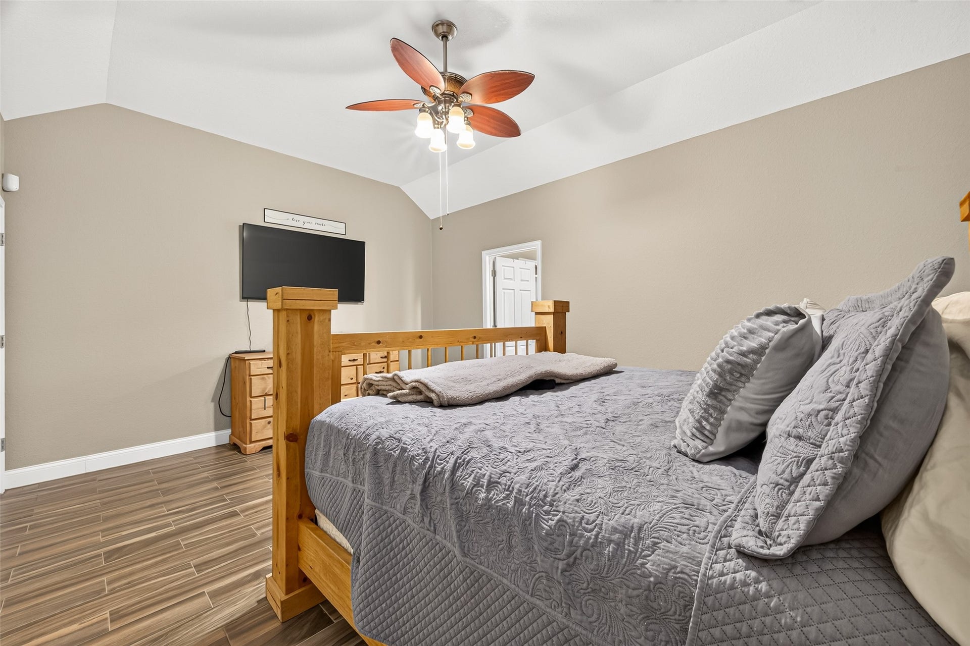 Comfort meets style in this spacious primary retreat, offering natural light, high ceilings, and a warm, welcoming atmosphere.