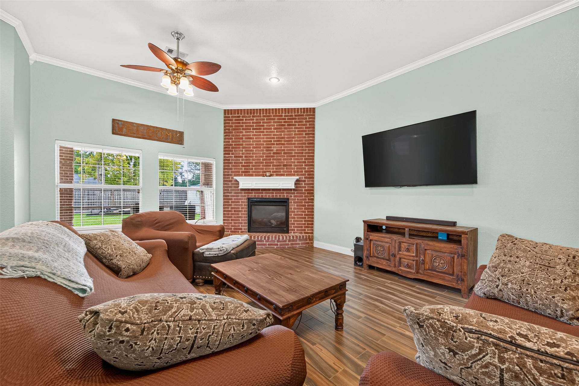 ozy up by the beautiful brick fireplace! This inviting living room offers generous space for comfortable everyday living and entertaining.