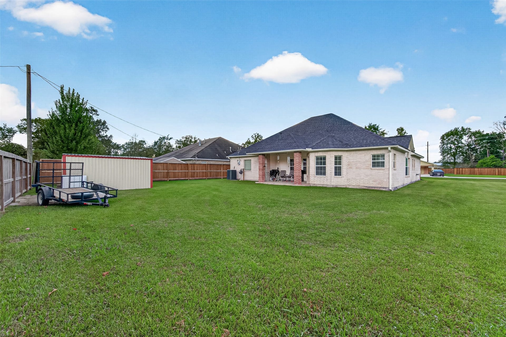 Look at all that room! This expansive, fully fenced backyard offers endless possibilities for outdoor entertaining, gardening, or simply enjoying the outdoors.