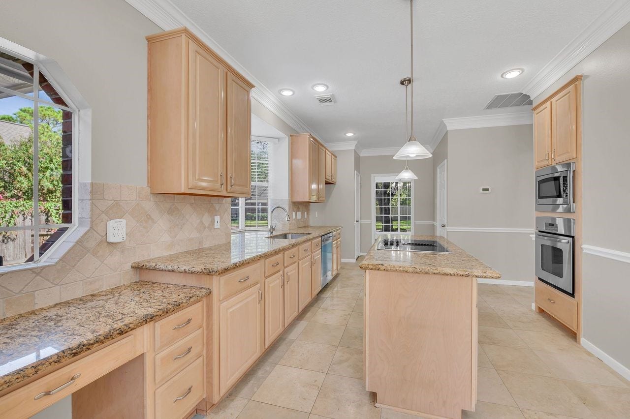 4131 Raven River Drive, Pasadena, TX 77059 Spacious kitchen features granite countertops, stainless steel appliances, abundant cabinetry and generous workspaceperfect for everyday living and entertaining.