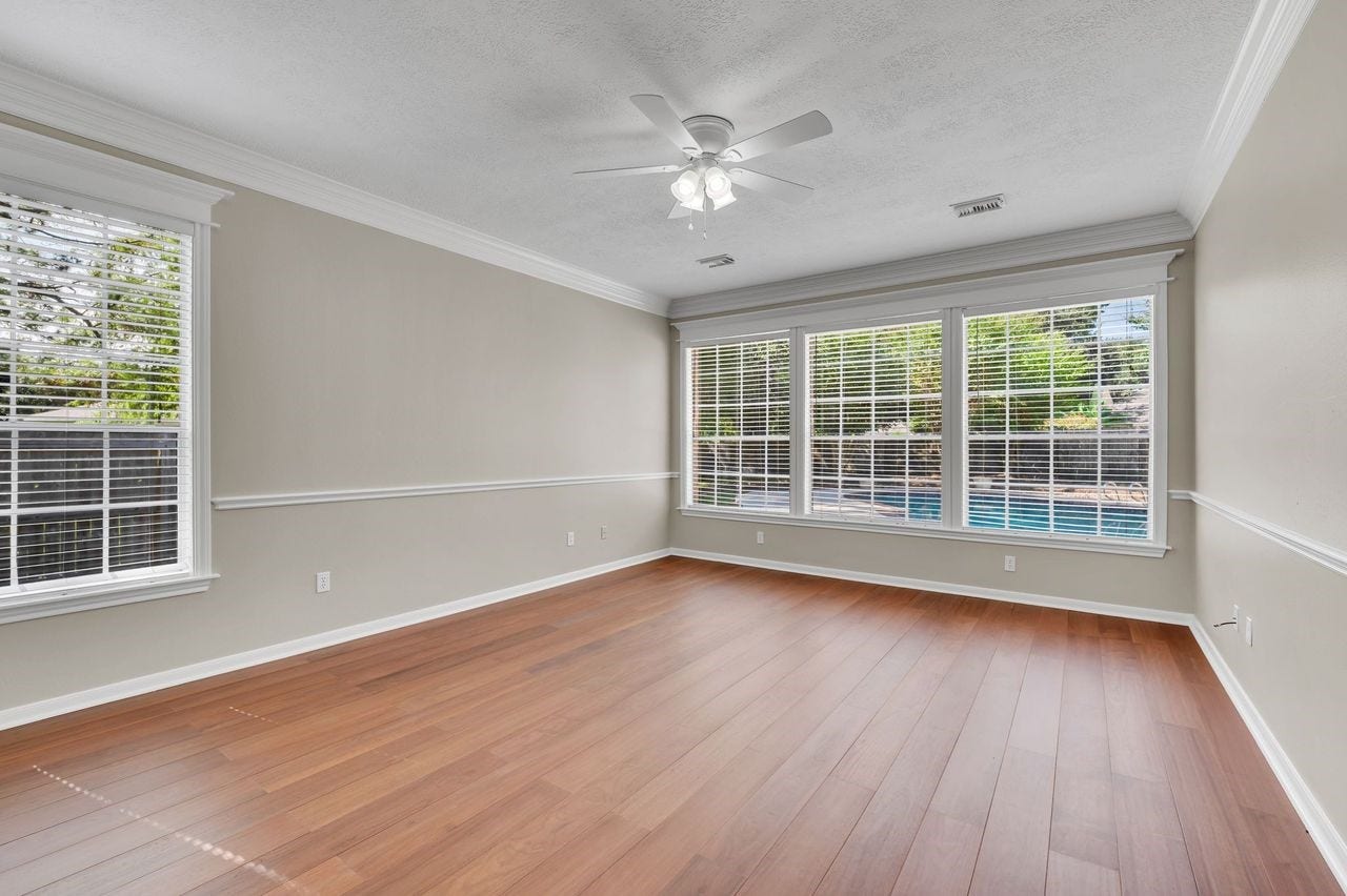 4131 Raven River Drive, Pasadena, TX 77059 First-floor primary suite offers a peaceful retreat with abundant natural light and beautiful views of the backyard and pool.