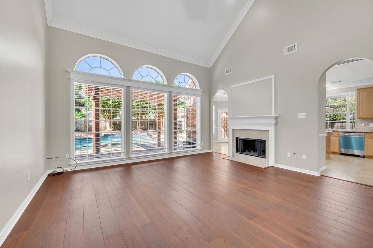 4131 Raven River Drive, Pasadena, TX 77059 Family Room/Den showcasing gorgeous view of backyard oasis - gas fireplace - wet bar - new wood flooring.