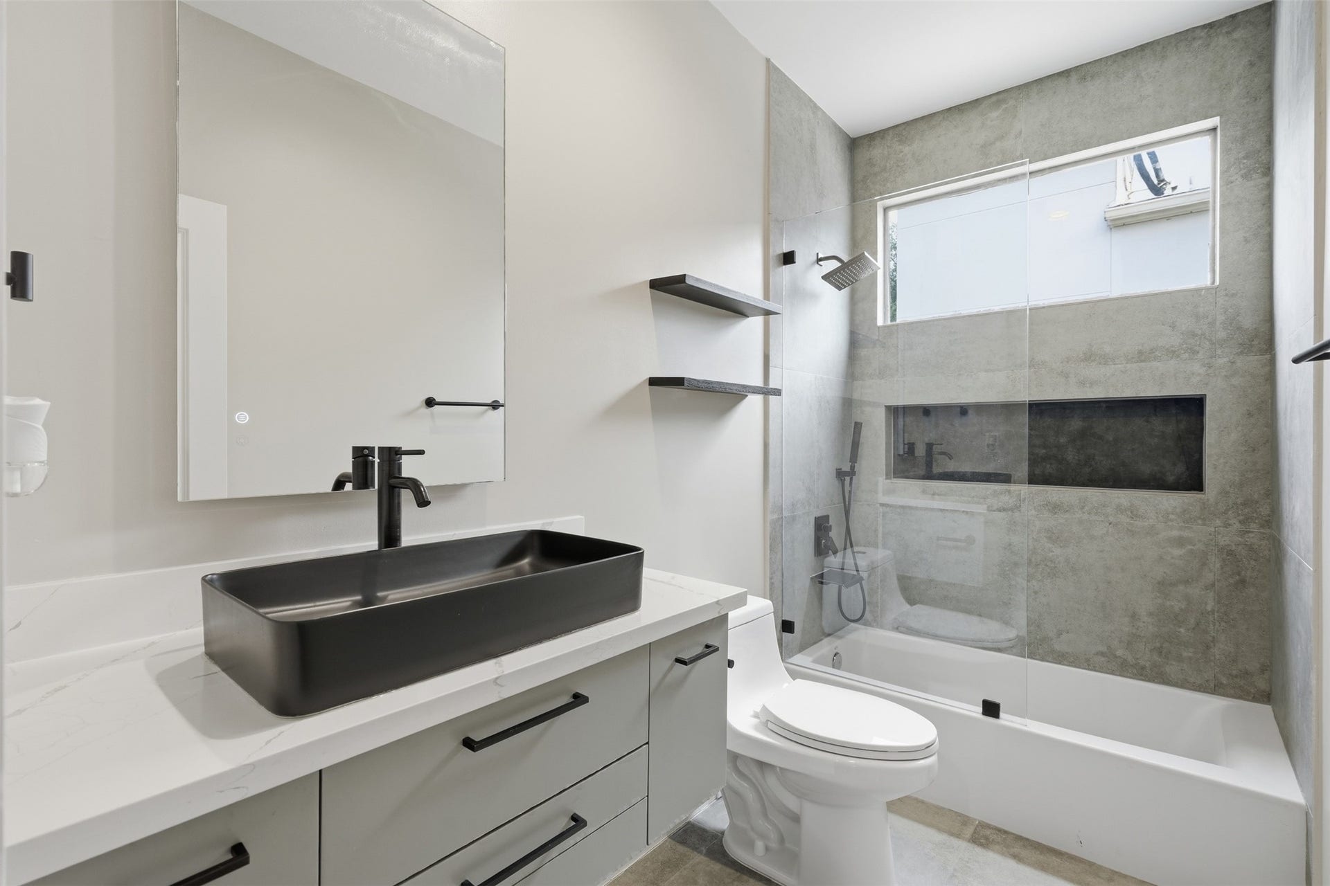 2109 Sul Ross Street, Houston, TX 77098 Beautifully renovated bathroom with modern fixtures and designer tilework