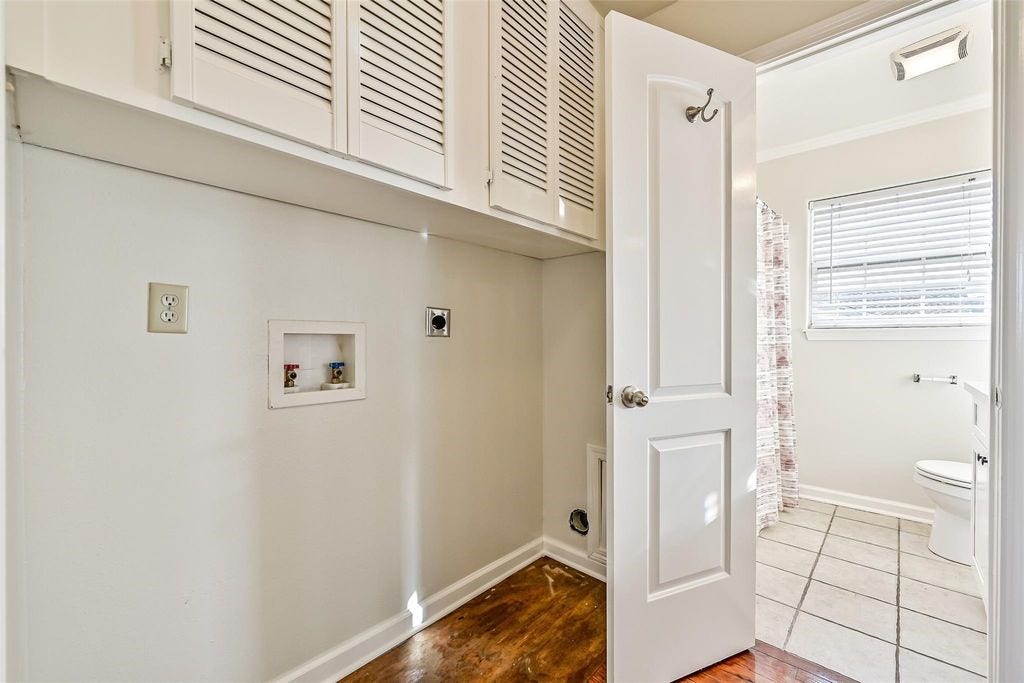 1029 62nd Street, #Up, Galveston, TX 77551 Washer and dryer connections with storage above and hall storage closet directly behind.