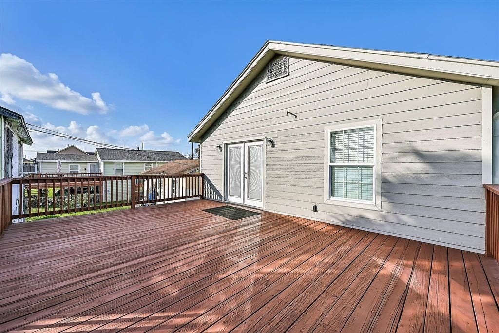 1029 62nd Street, #Up, Galveston, TX 77551 Large outdoor patio that oversees the spacious backyard and additional staircase. Great for hosting guests or just enjoying the weather.
