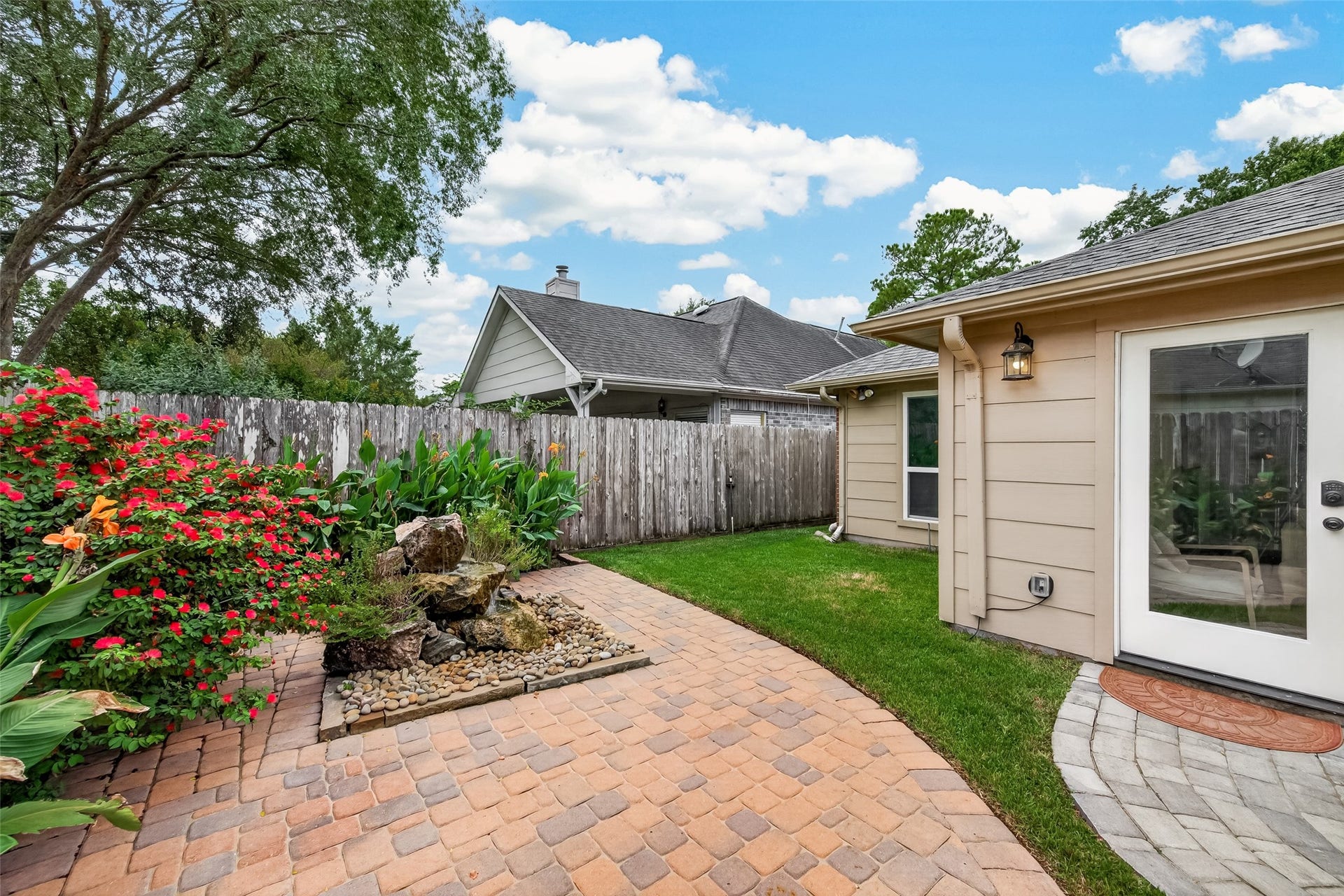 1518 Watts Avenue, Katy, TX 77493 The backyard is immaculate and features a water fountain and mature landscaping that adds color throughout the year.