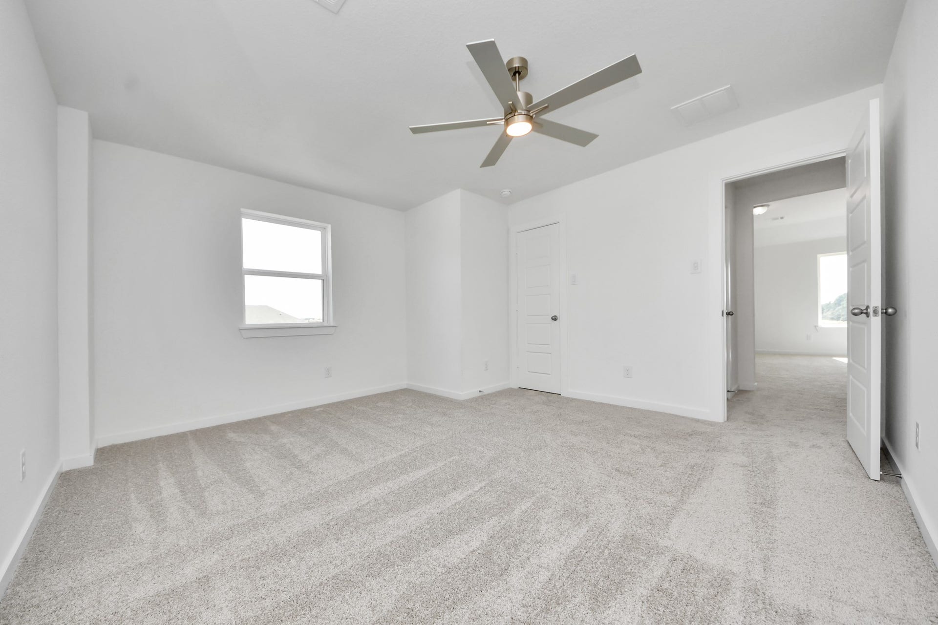 3057 Spoolwood Trail, Magnolia, TX 77355 Generously sized secondary bedrooms featuring spacious closets, soft and inviting carpeting underfoot, large windows allowing plenty of natural light, and the added touch of privacy blinds for your personal retreat.