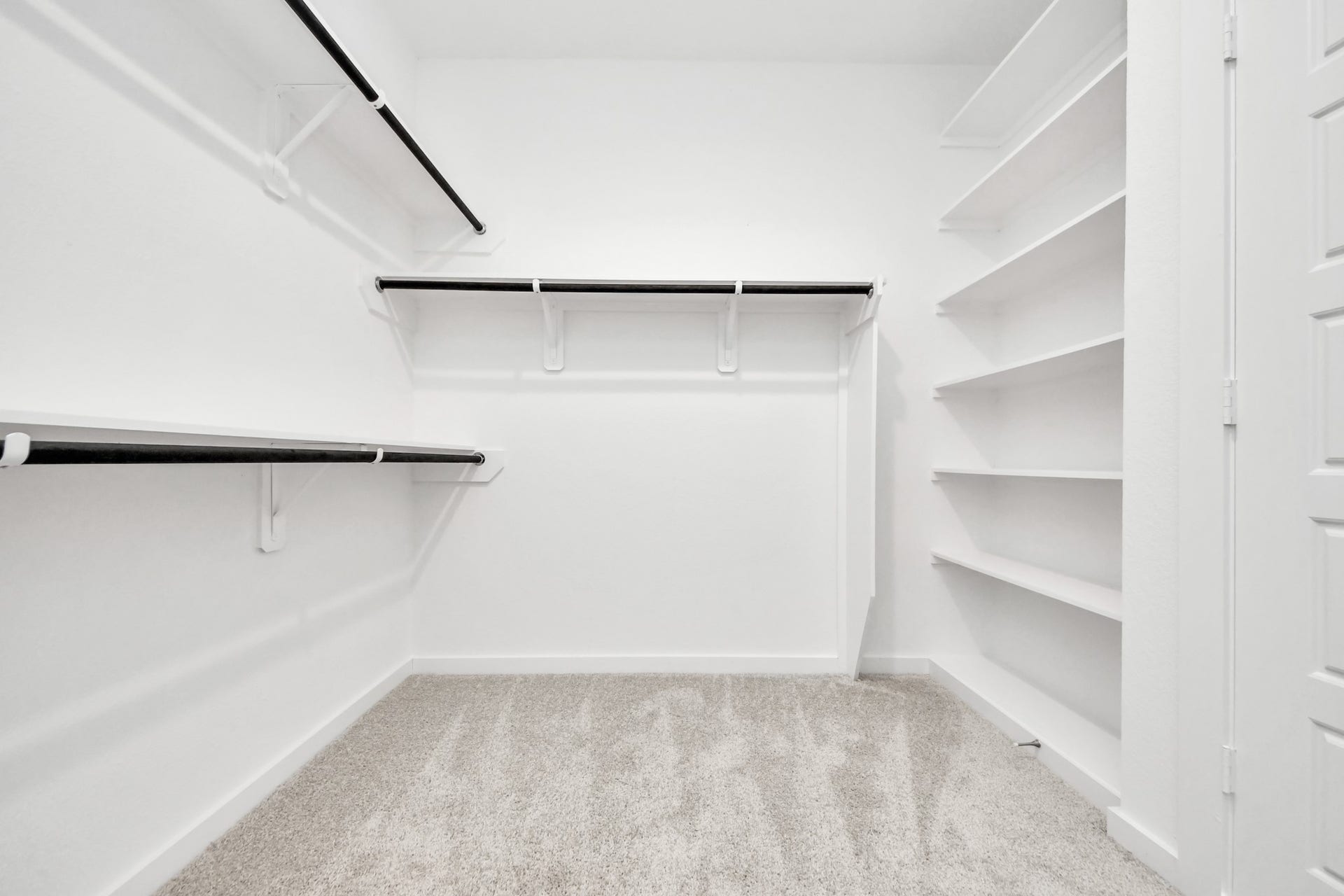 3057 Spoolwood Trail, Magnolia, TX 77355 Walk-in closet that epitomizes luxury and practicality. This generously sized space features built-in shelving, offering abundant room for impeccable organization. High ceilings and recessed lighting create a bright and welcoming ambiance.