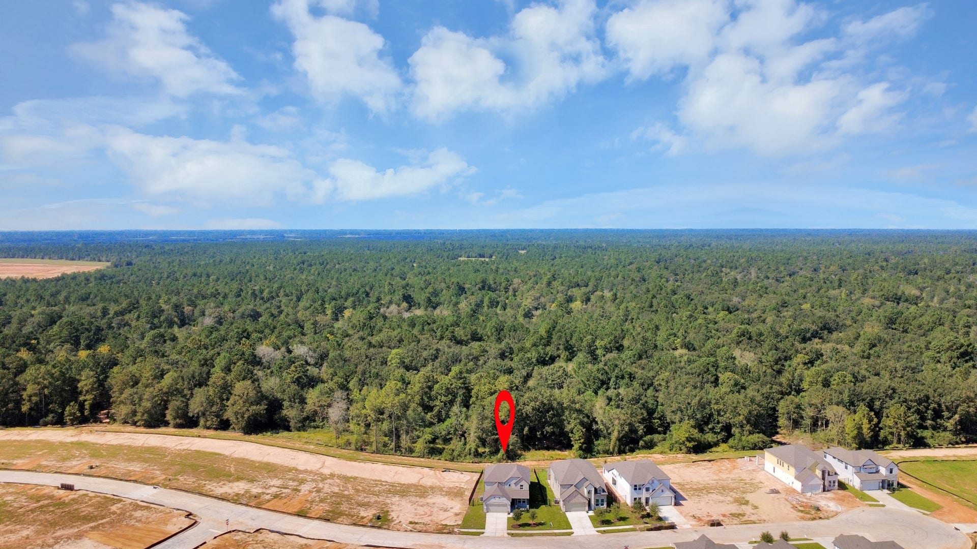 3057 Spoolwood Trail, Magnolia, TX 77355 An aerial view of a spacious subdivision lot, highlighting a well-maintained yard and a fully fenced perimeter, offering both privacy and expansive outdoor space.