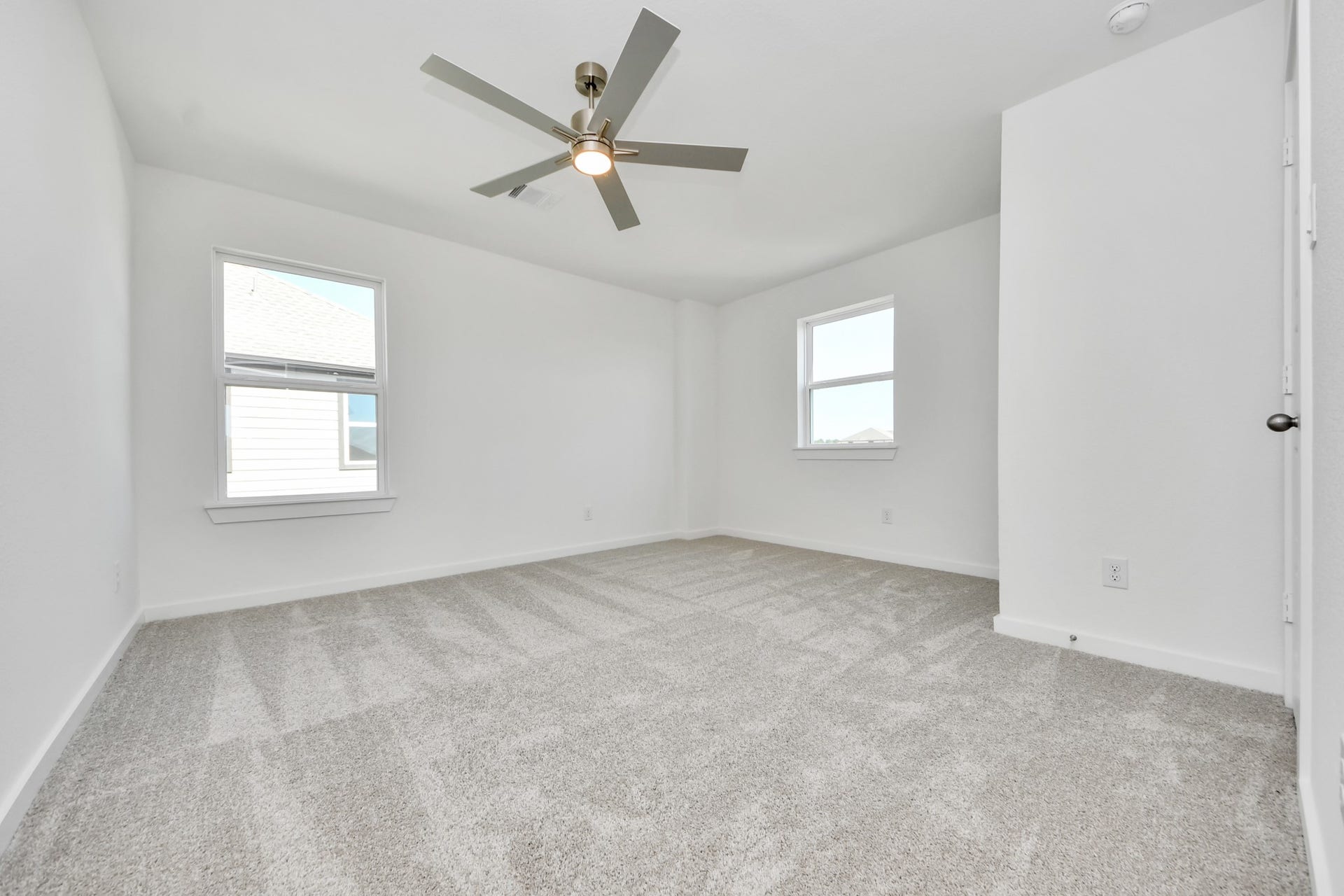 3057 Spoolwood Trail, Magnolia, TX 77355 Secondary bedroom features plush carpeting, large windows that let in plenty of natural light, bright paint, and spacious closets.