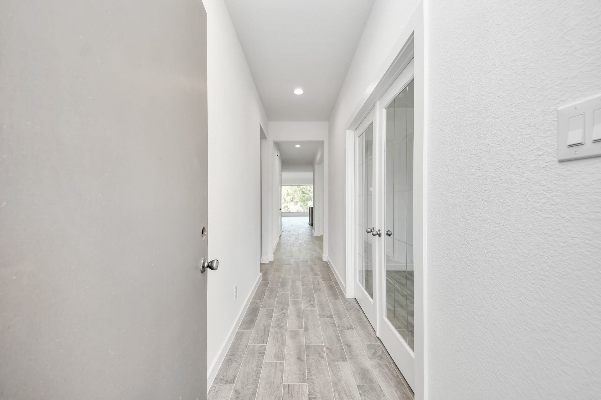 3057 Spoolwood Trail, Magnolia, TX 77355 As you step into the threshold of this luxurious home, you'll soon be welcomed by an elegant glass door (to be installed). Inside, soaring ceilings amplify the spaciousness, while the refined wood-look tile flooring and oversized baseboards exude sophistication and charm.