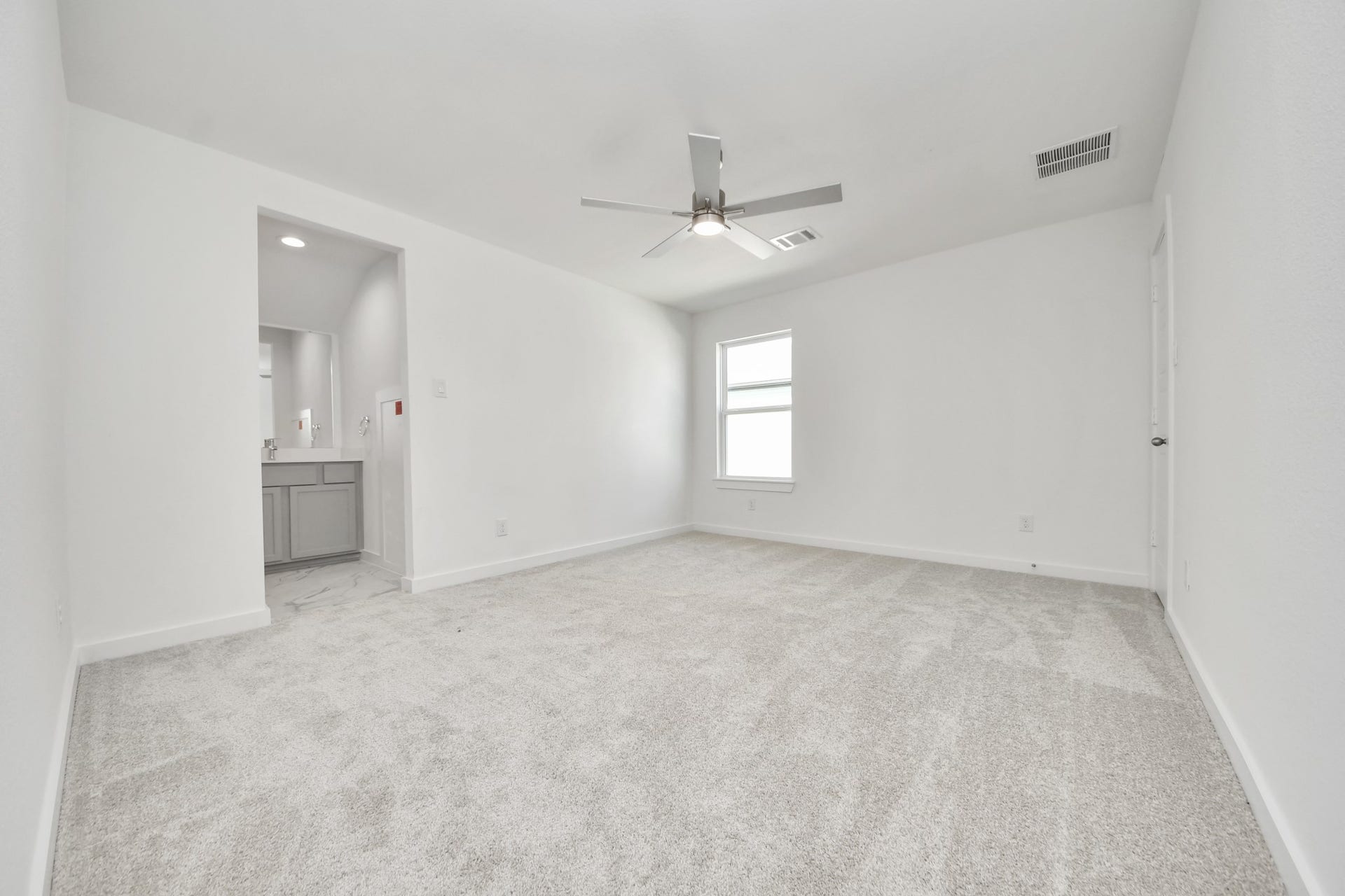 3057 Spoolwood Trail, Magnolia, TX 77355 Secondary bedroom features plush carpeting, large windows that let in plenty of natural light, bright paint, and spacious closets.
