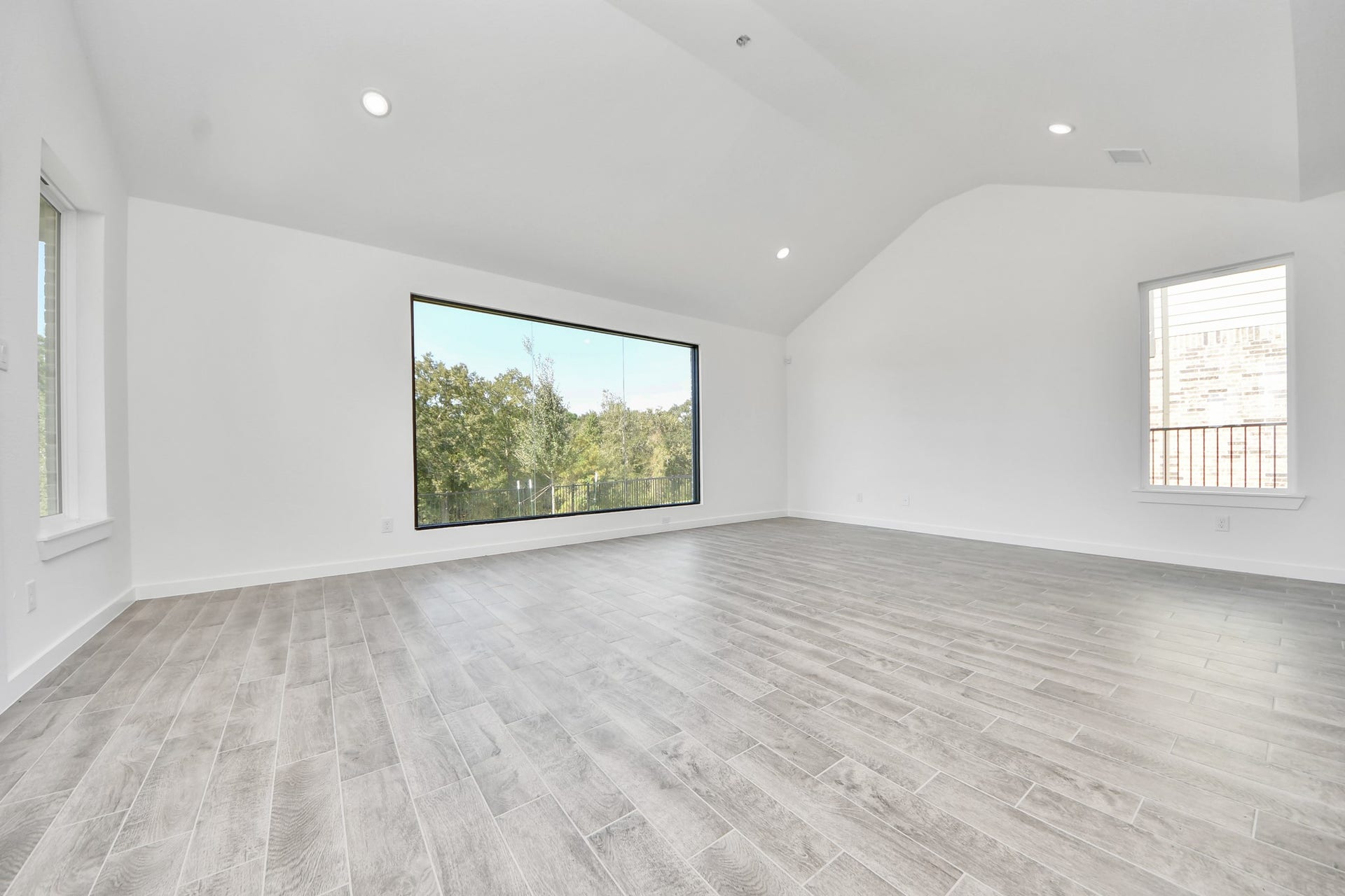 3057 Spoolwood Trail, Magnolia, TX 77355 Take another glimpse into the heart of the home with this additional view of the family rooma sprawling space ready to accommodate all your gatherings.