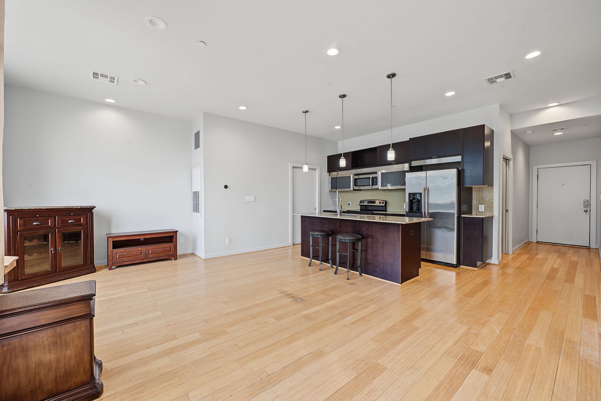 Enjoy the spacious, open feel of this contemporary living area, where the living room flows seamlessly into the kitchen! The open-concept design creates an inviting atmosphere that's perfect for everyday living and effortless entertaining.
