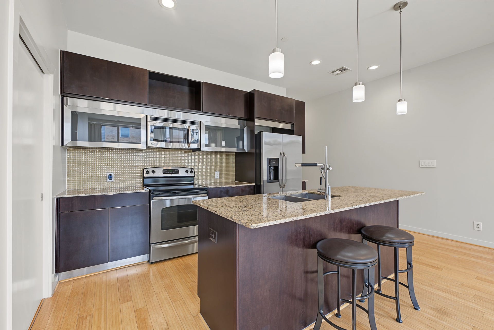 A Kitchen Designed To Gather! This beautifully appointed kitchen is anchored by a sweeping island with breakfast bar seating and extra storage space.