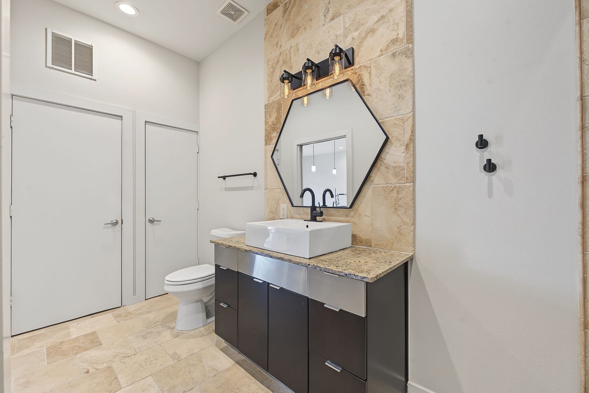 Modern Style in Every Detail! Beautiful travertine tile flooring, rich granite countertops, and sleek European-style cabinetry create a sophisticated, contemporary atmosphere. Recessed lighting complements the clean lines and thoughtfully selected finishes, bringing together style and everyday functionality.