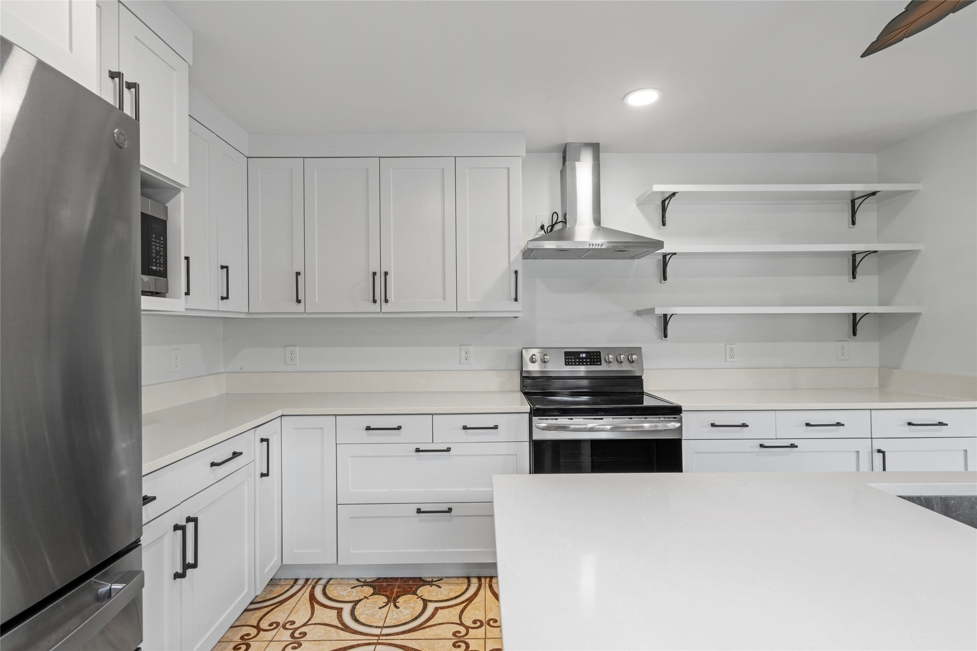 The kitchen's cooking zone, showcasing the practical layout with sleek appliances ready for the home chef.