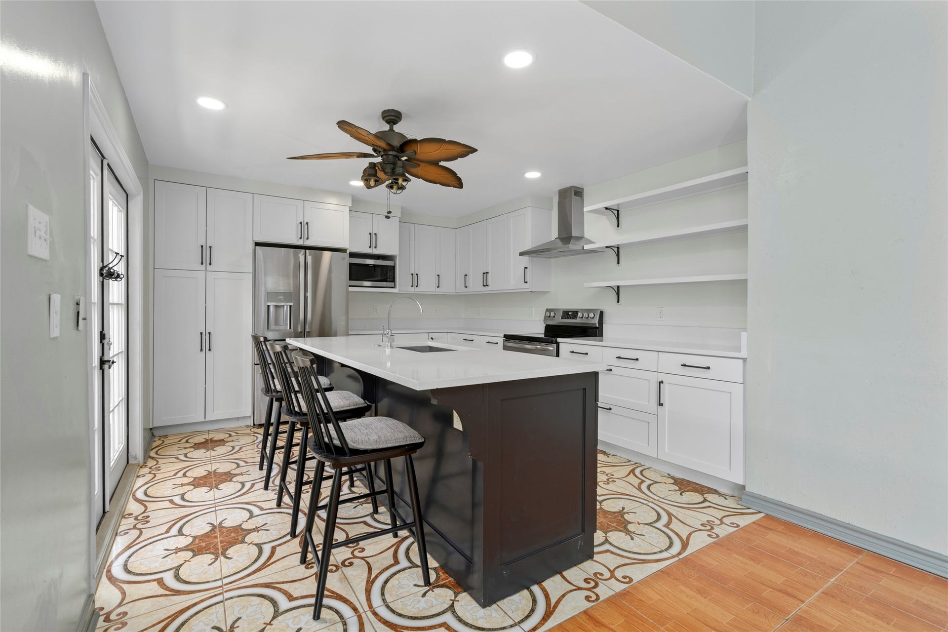 Another angle of the kitchen island, highlighting the generous counter space ideal for meal prep and entertaining.
