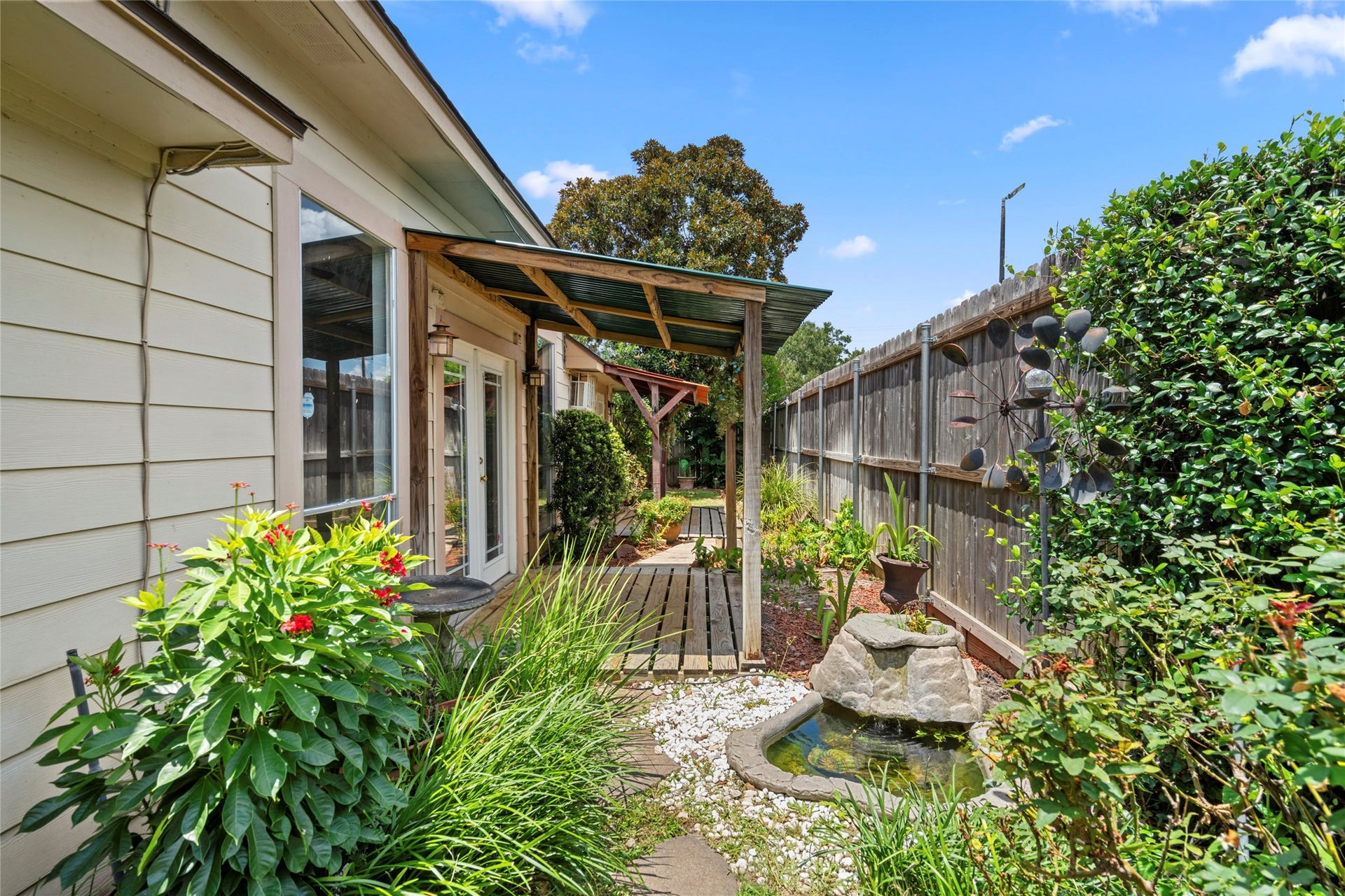 The side yard garden featuring a charming fountain, adding a tranquil touch to the outdoor space.