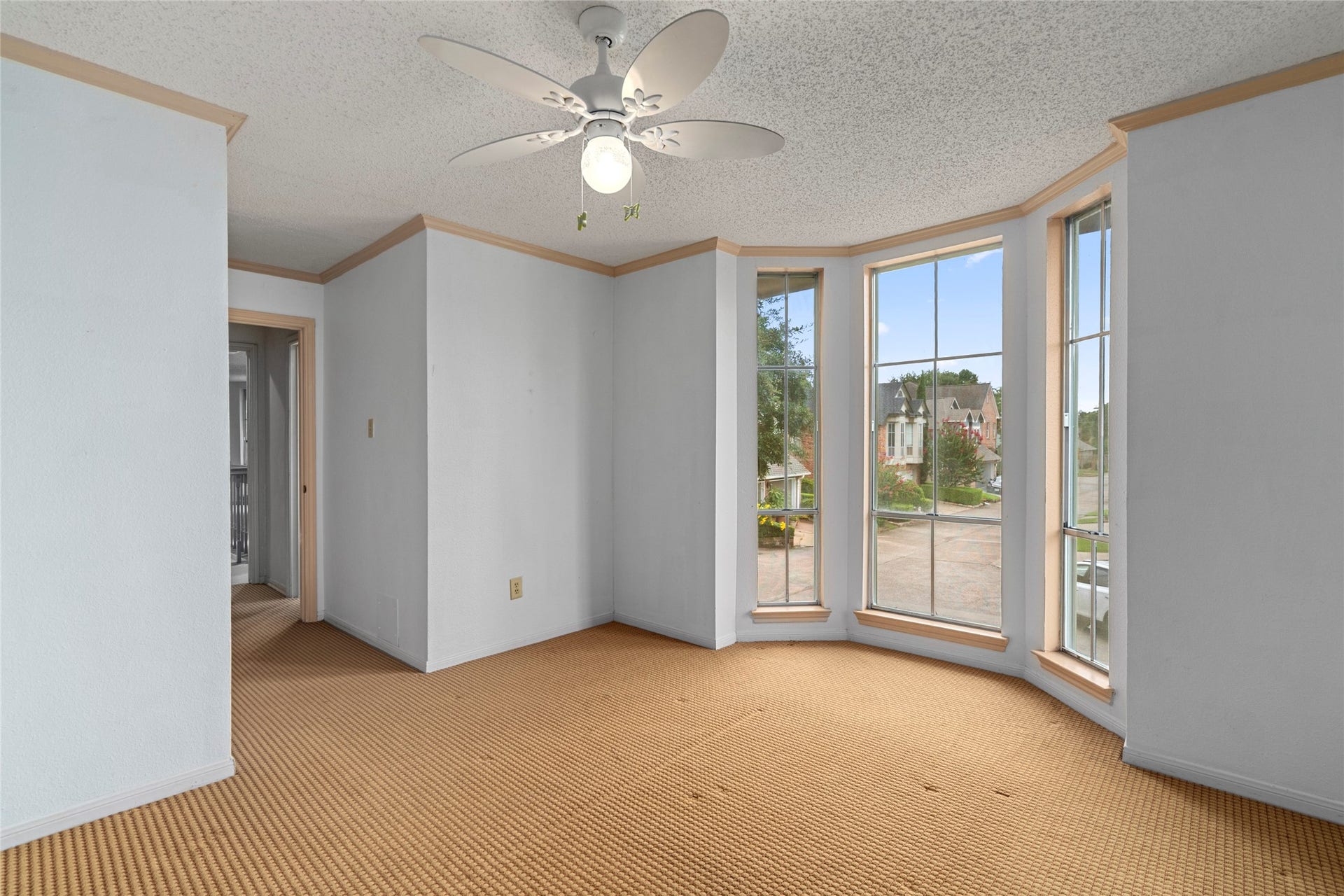 Another view of the bedroom, where a charming bay window bathes the space in natural light, creating a warm and inviting retreat.