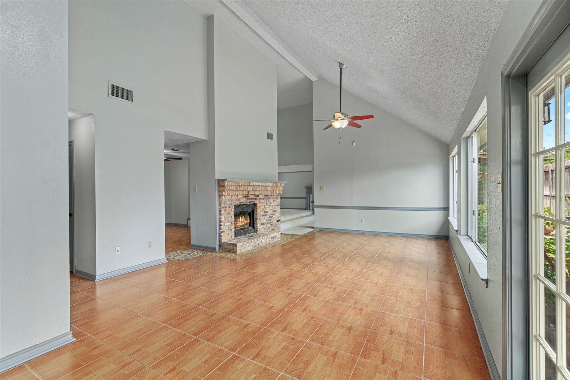 A wide shot of the open dining area, showing off the flexible floor plan and abundance of natural light pouring through the windows.