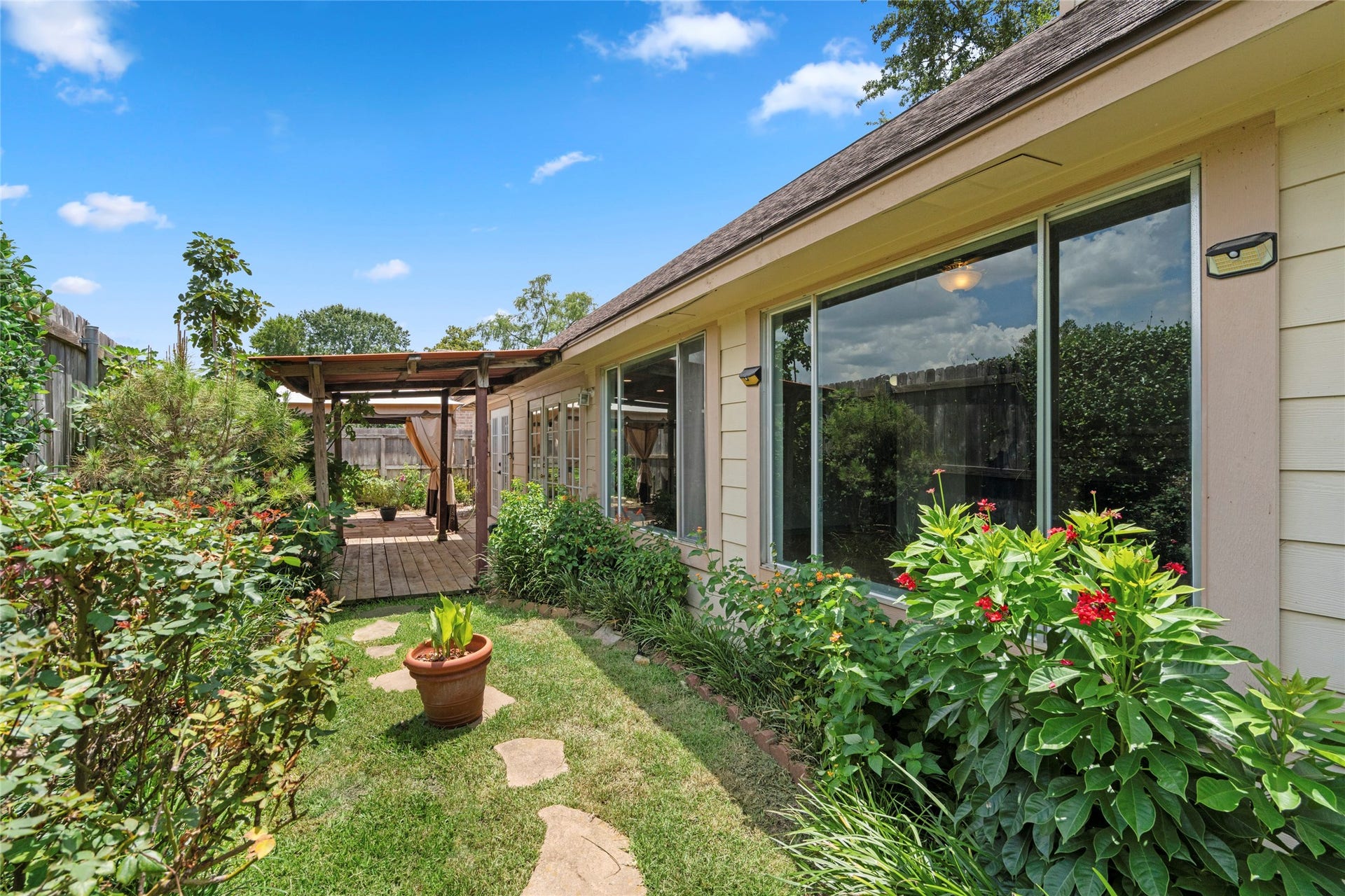 A view of the backyard garden with pergola, showcasing the peaceful, private setting that completes this exceptional outdoor retreat.