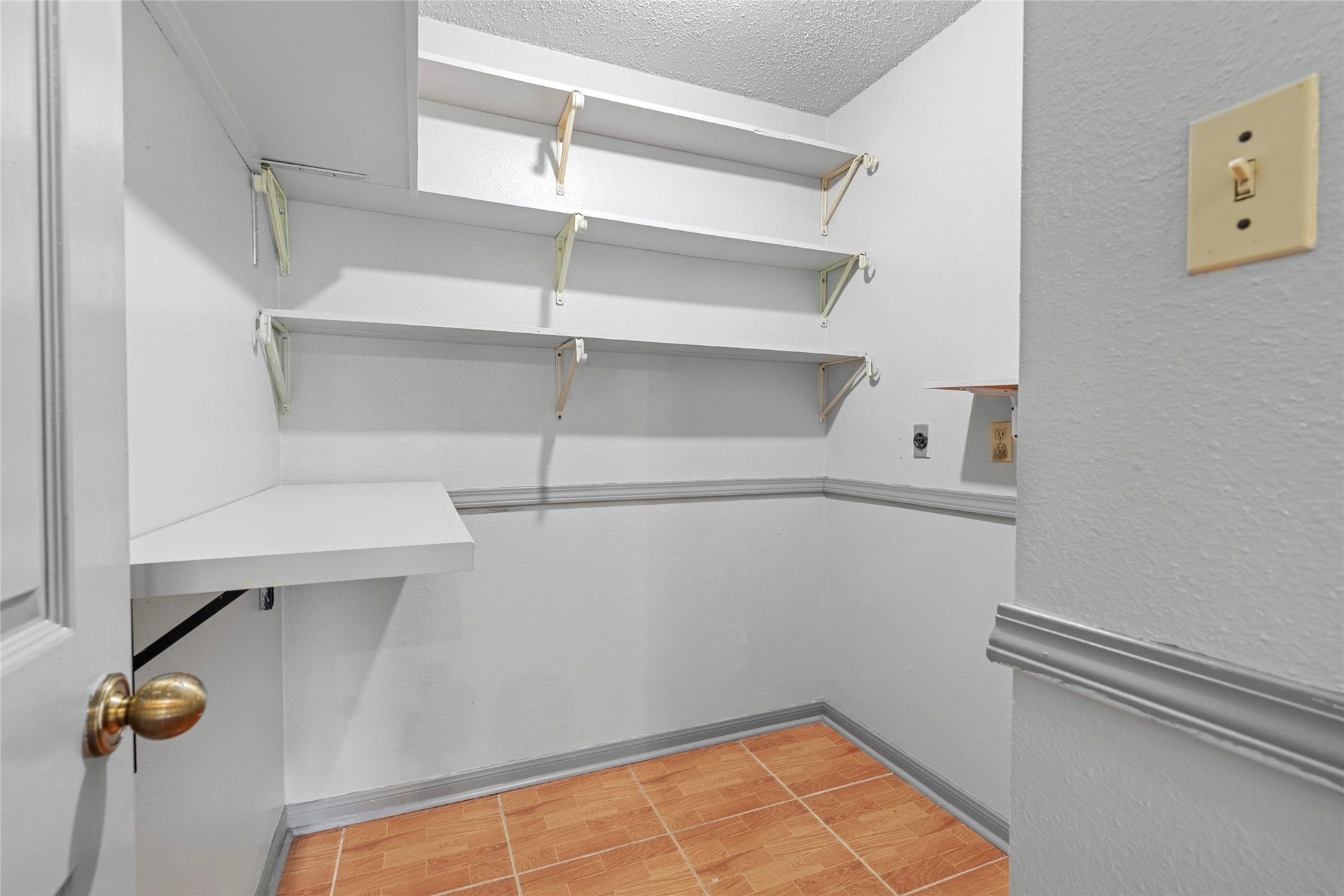 A closet or storage area with built-in shelving, showcasing the thoughtful organizational space this home provides.