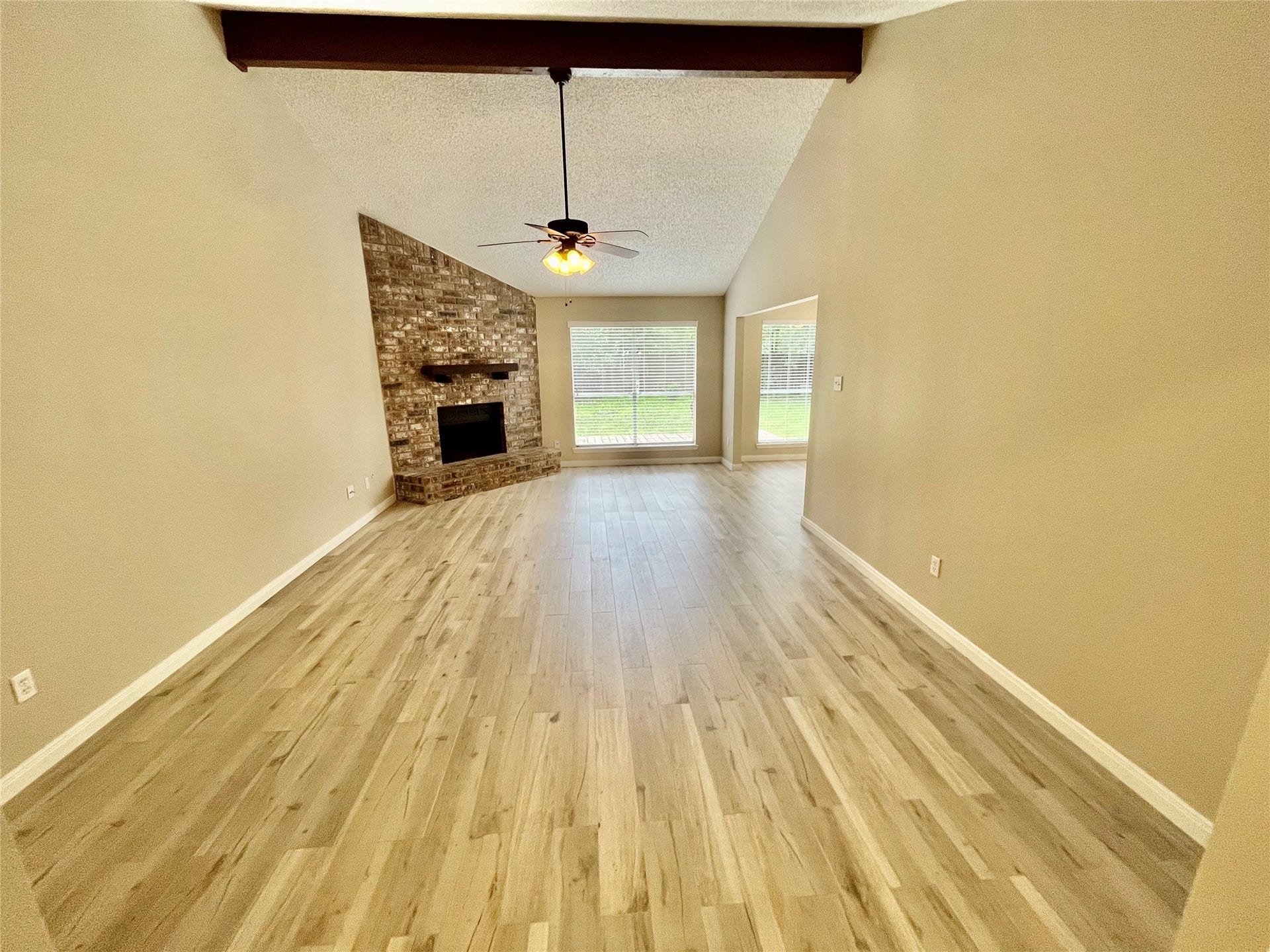 6 Leverwood Court, The Woodlands, TX 77381 Great room view toward the front entry highlights the home's open layout and fireplace.