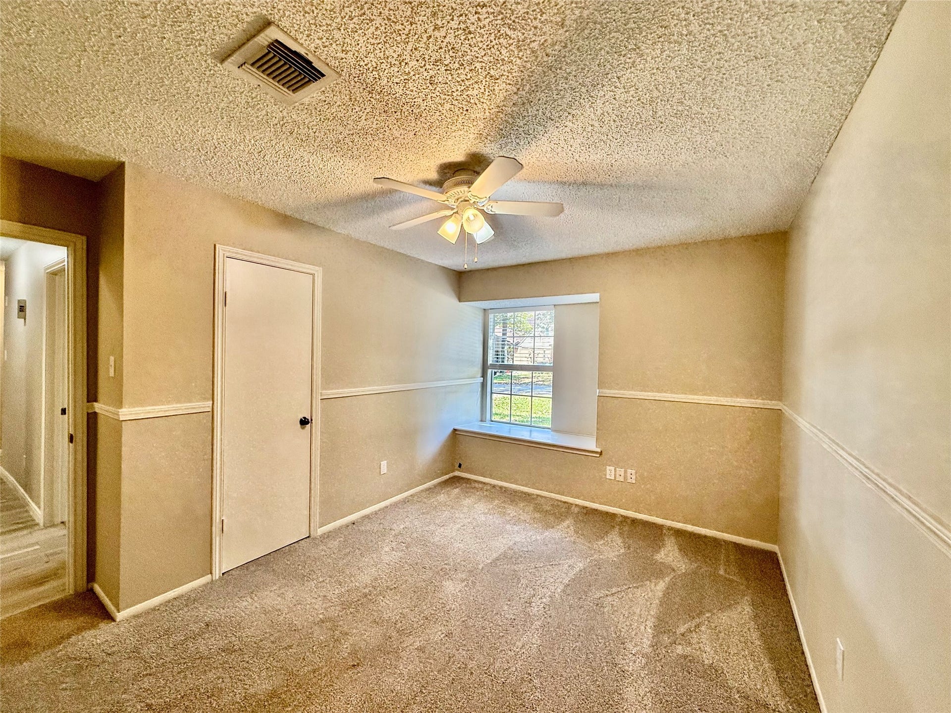 6 Leverwood Court, The Woodlands, TX 77381 Additional secondary bedroom offers flexible space for guests, family, or a home office. Notice the chair rail accent. New Faux wood blinds
