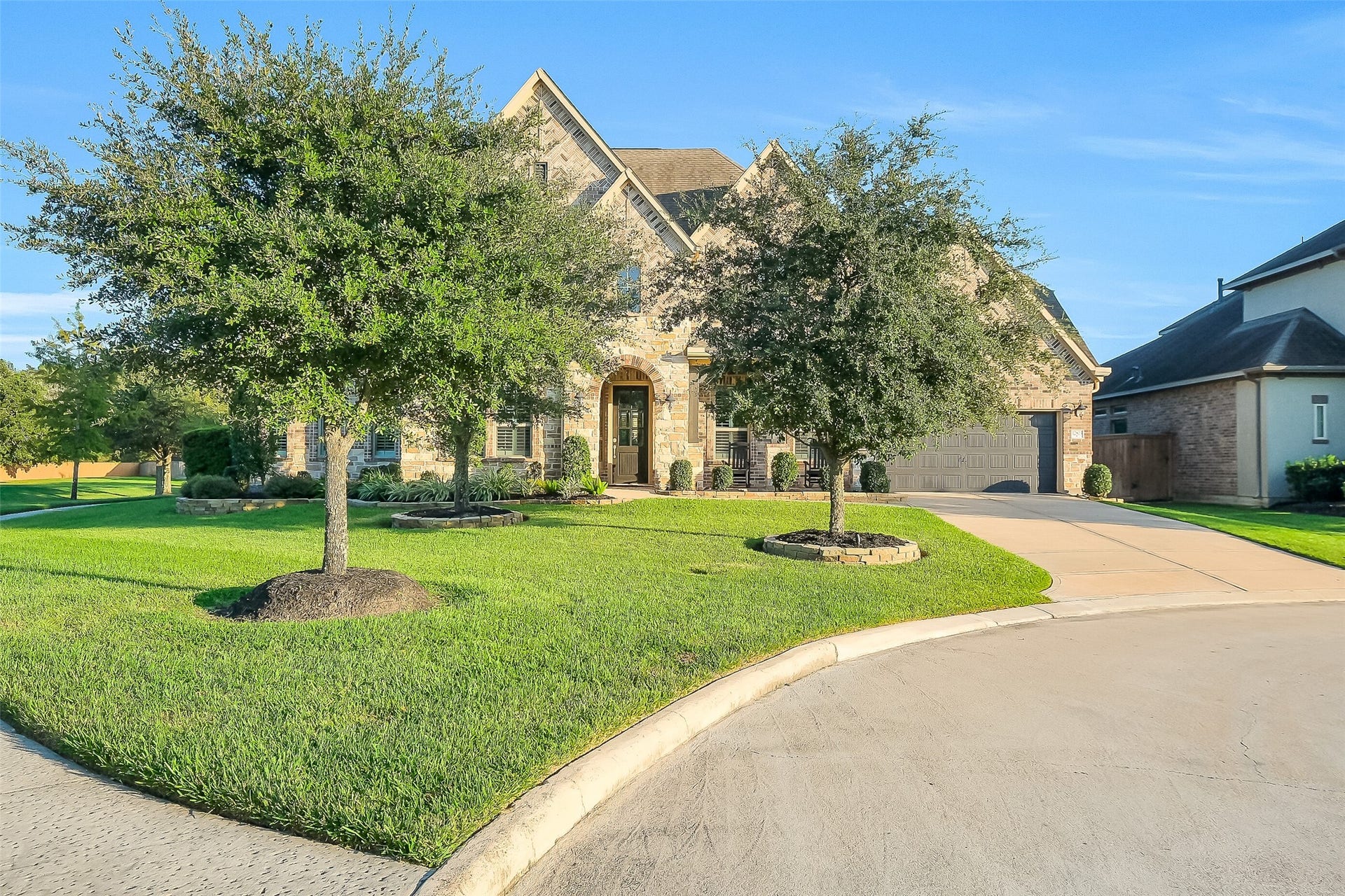 Your home features a beautiful brick and stone facade along with mature landscaping and brick landscaping pavers that match your home and ensures a cohesive and put together look.